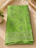 Elegant parrot green saree featuring intricate silver motifs and delicate buttas throughout with silver border