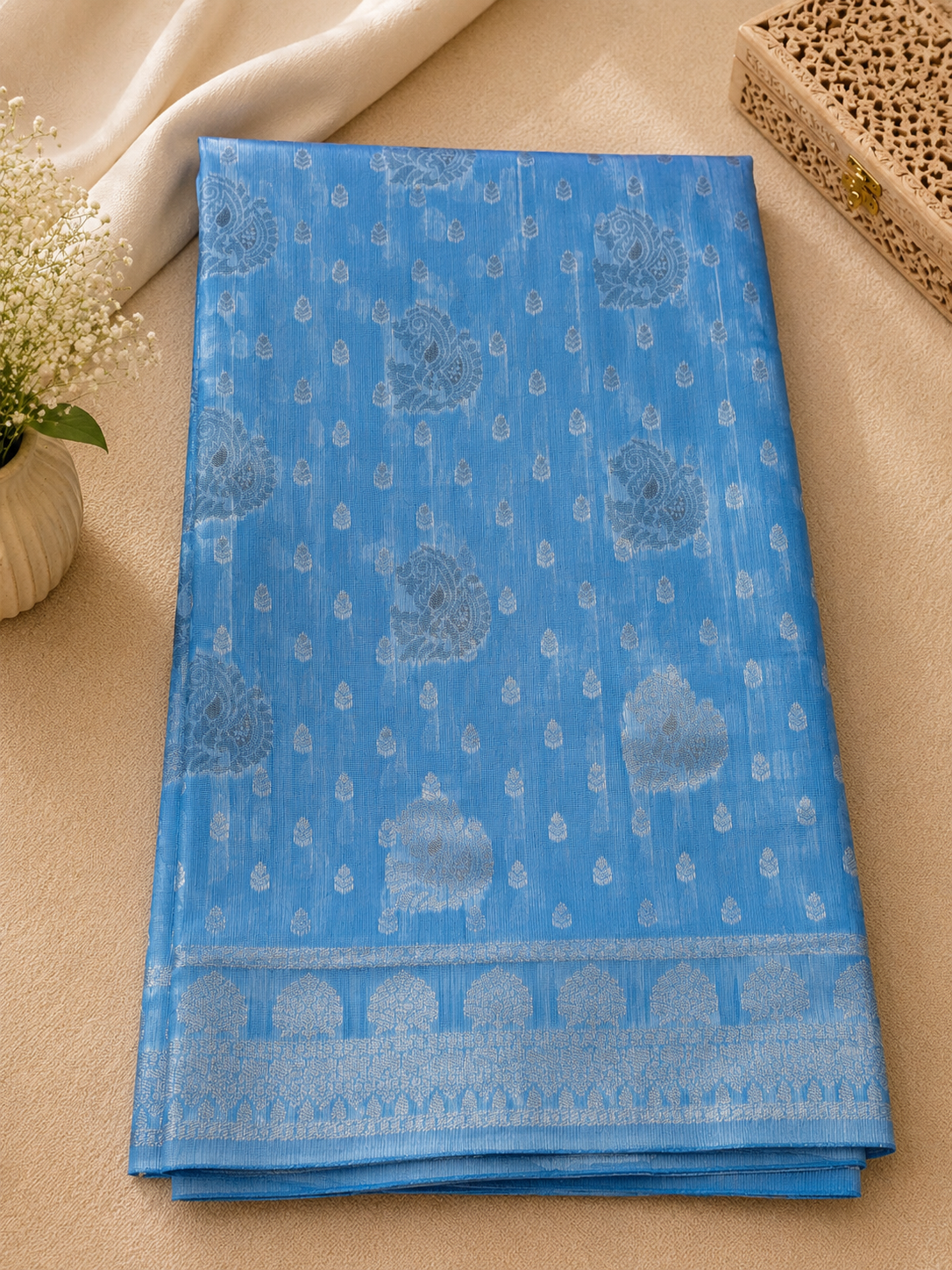 Elegant sky blue Cotton saree featuring intricate silver paisley motifs and delicate detailing with silver border