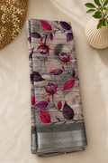 Elegant grey floral printed saree featuring graceful pink and purple botanical motifs on a subtle textured base. silver zari border- Cotton Saree