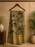 Elegant olive green saree featuring a soft floral print in earthy tones. The beautifully woven golden zari border- Satin Tissue Saree