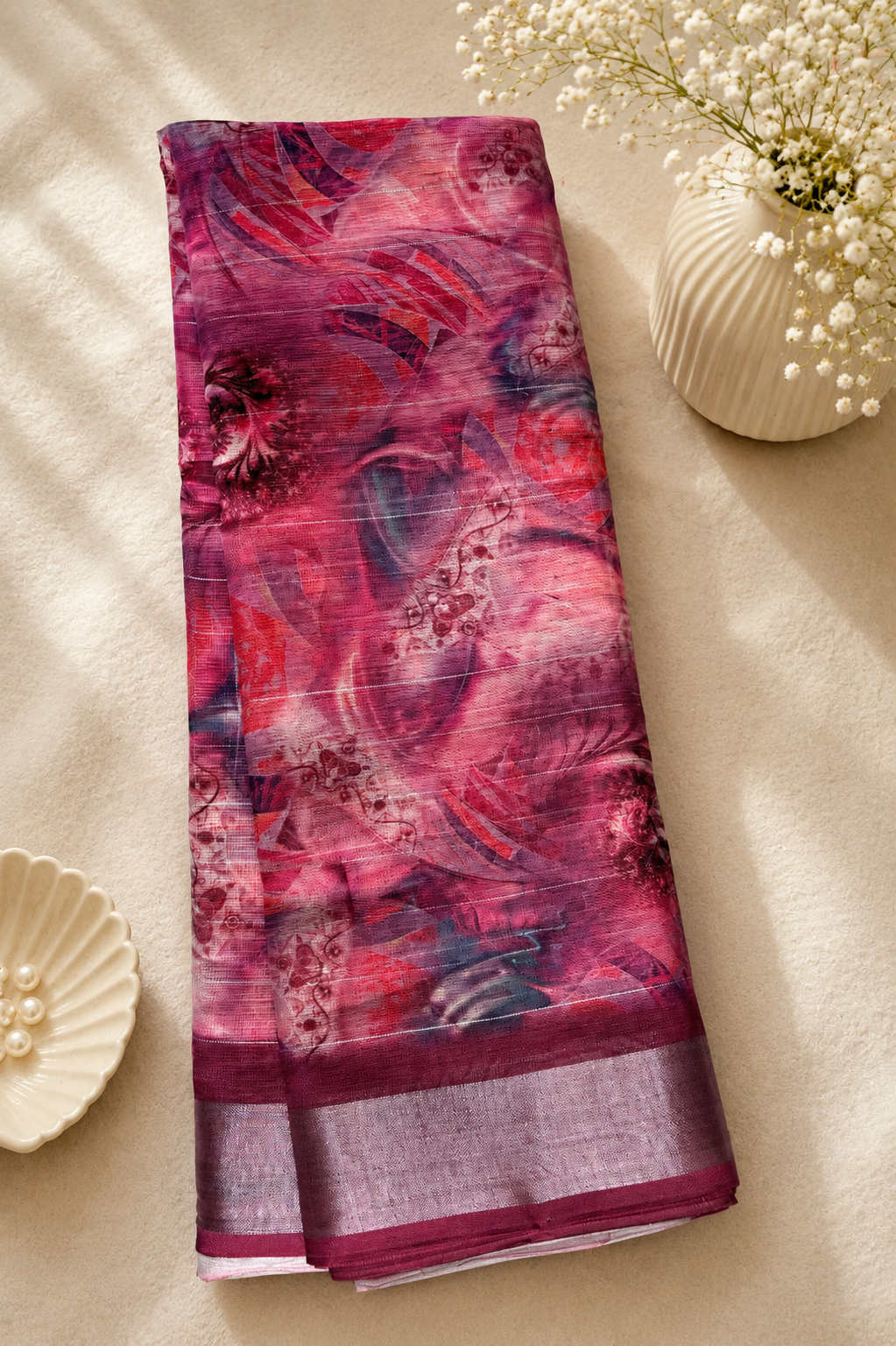 Elegant wine pink printed saree featuring an elegant abstract floral design in rich shades of pink, purple, and maroon. silver zari border- Cotton Saree