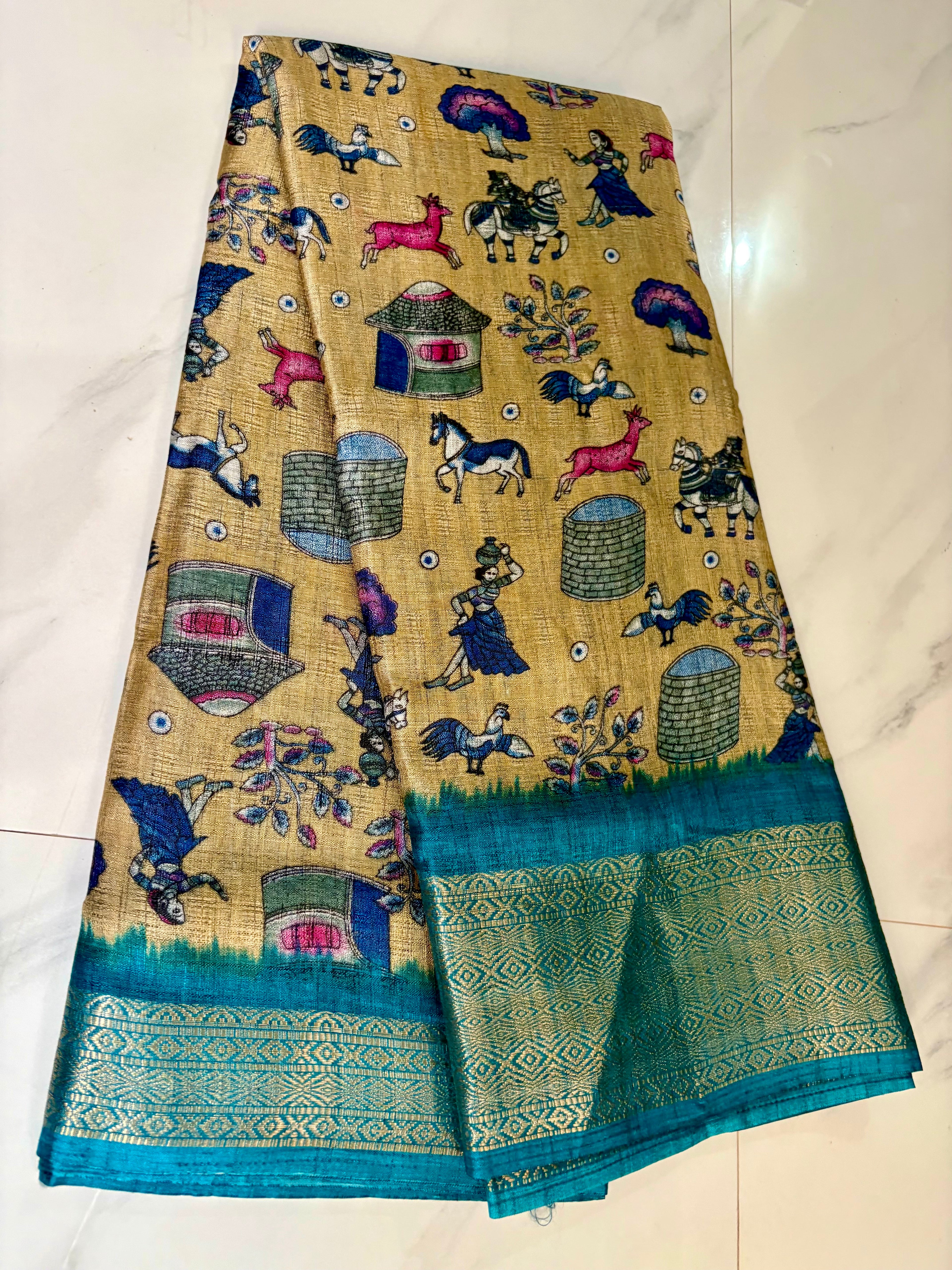 Beautiful Beige Khadi Cotton Saree Featuring vibrant traditional village-life and art prints with Rich Blue zari woven border.
