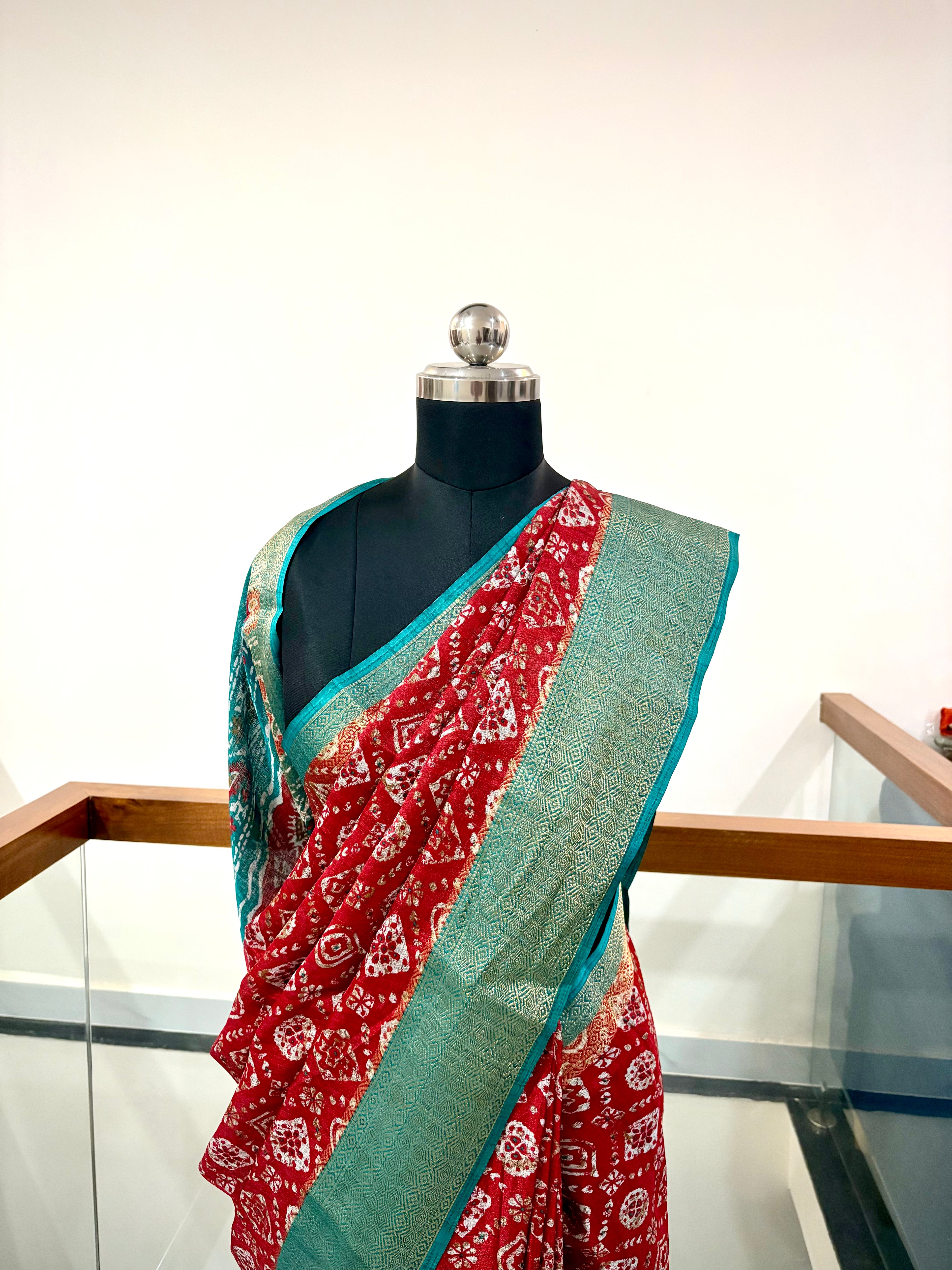 Vibrant Red Saree With Traditional Printed Motifs throughout with Beautiful Mint Green Border Woven Gold Zari Border.