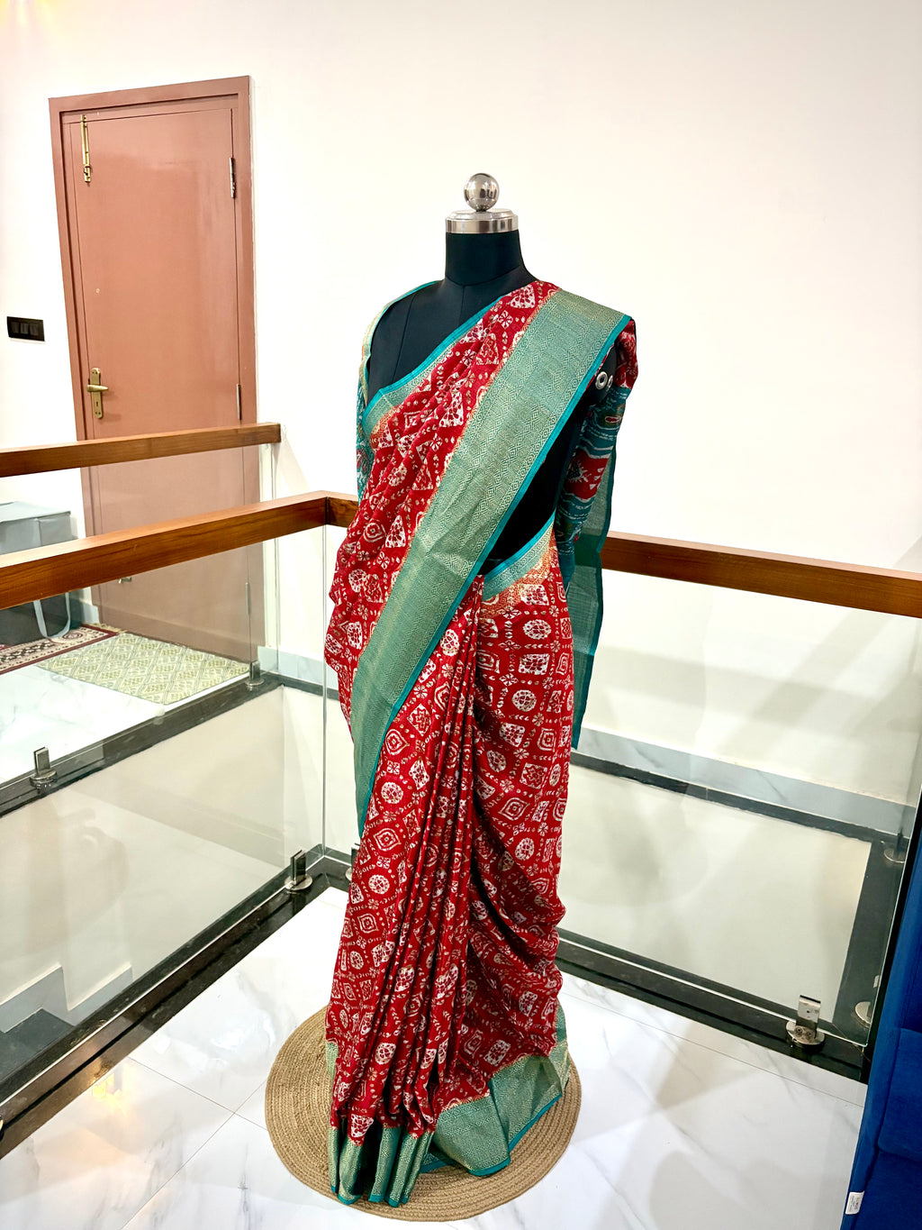 Vibrant Red Saree With Traditional Printed Motifs throughout with Beautiful Mint Green Border Woven Gold Zari Border.