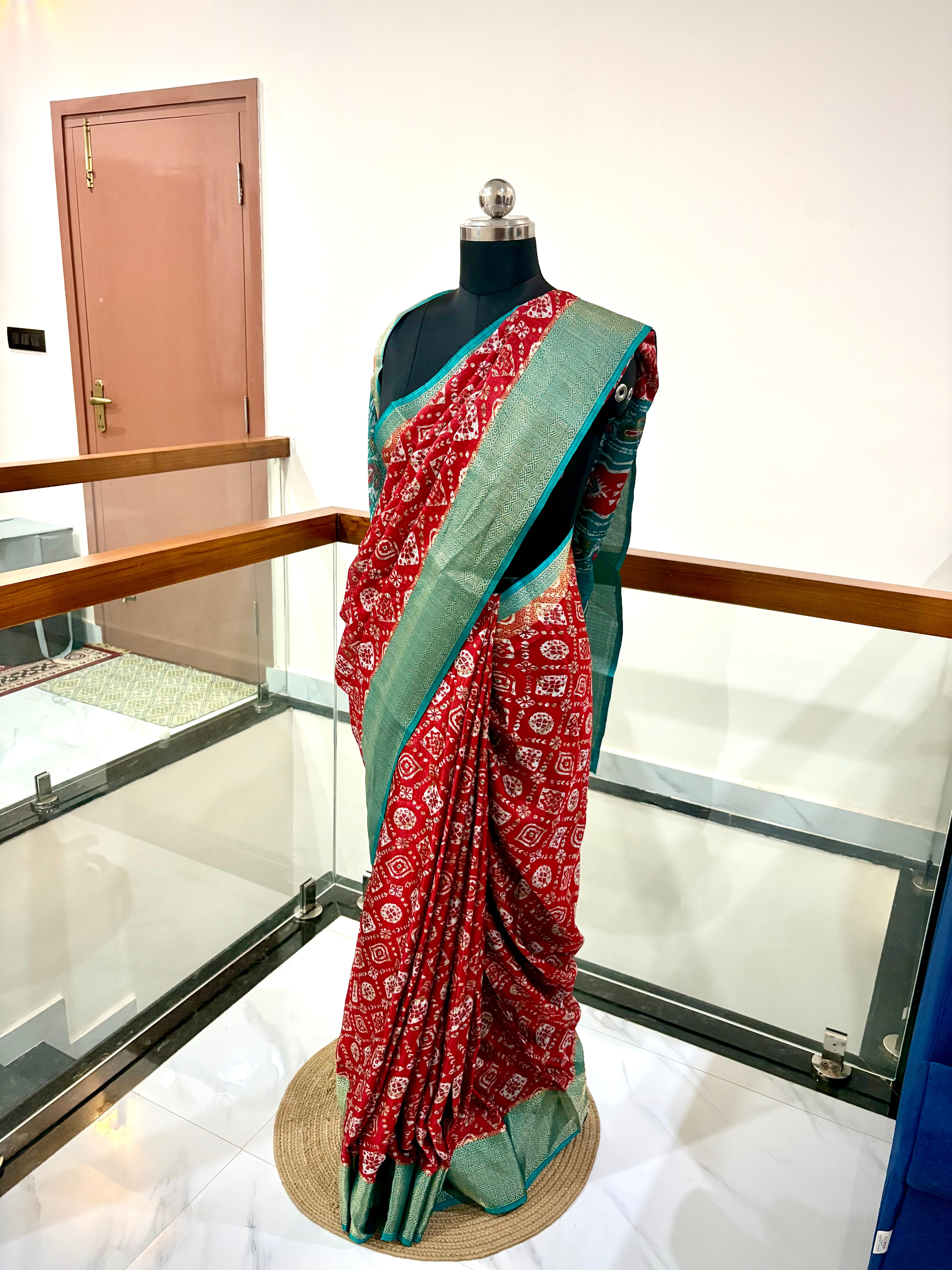 Vibrant Red Saree With Traditional Printed Motifs throughout with Beautiful Mint Green Border Woven Gold Zari Border.
