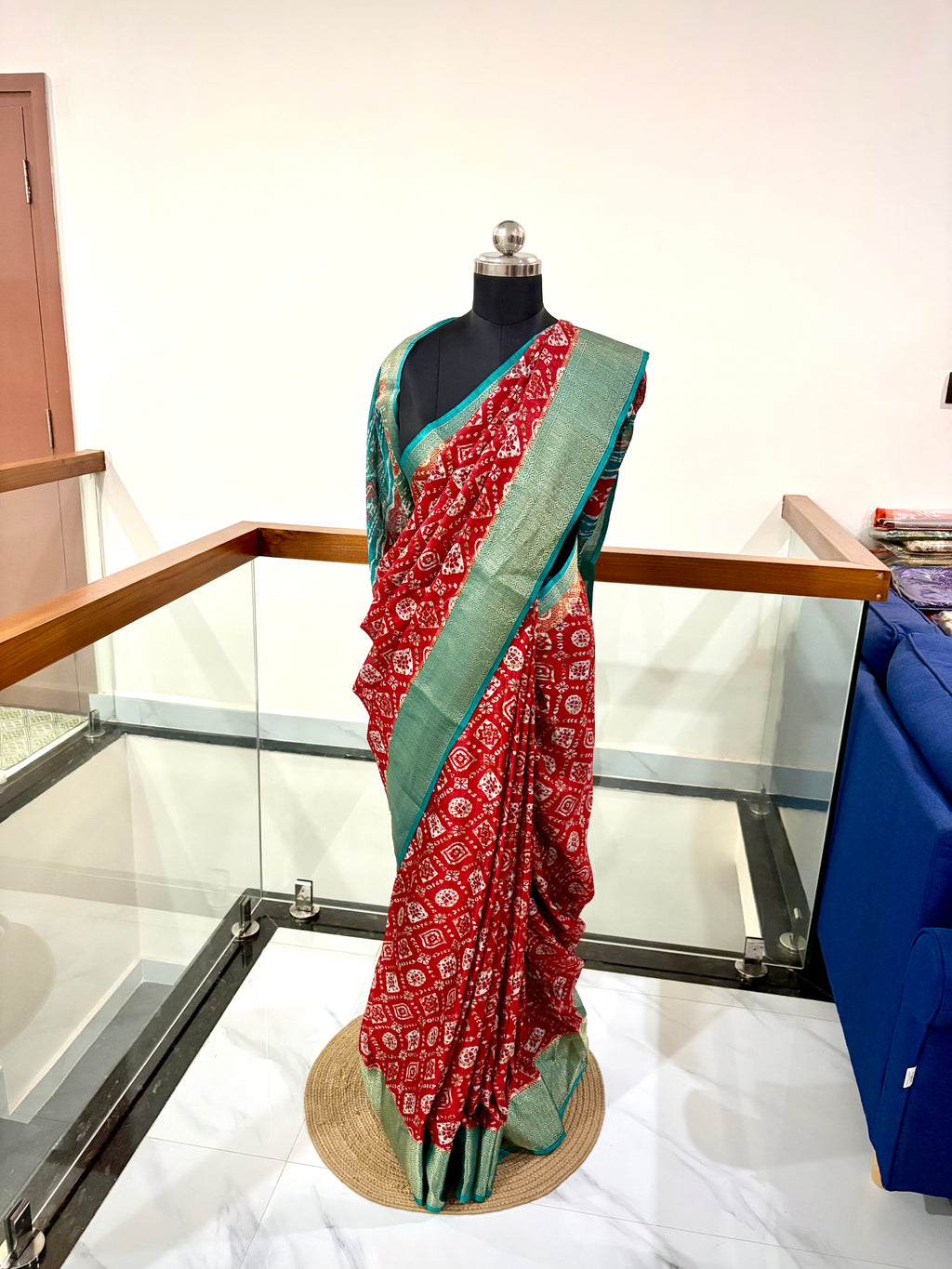 Vibrant Red Saree With Traditional Printed Motifs throughout with Beautiful Mint Green Border Woven Gold Zari Border.