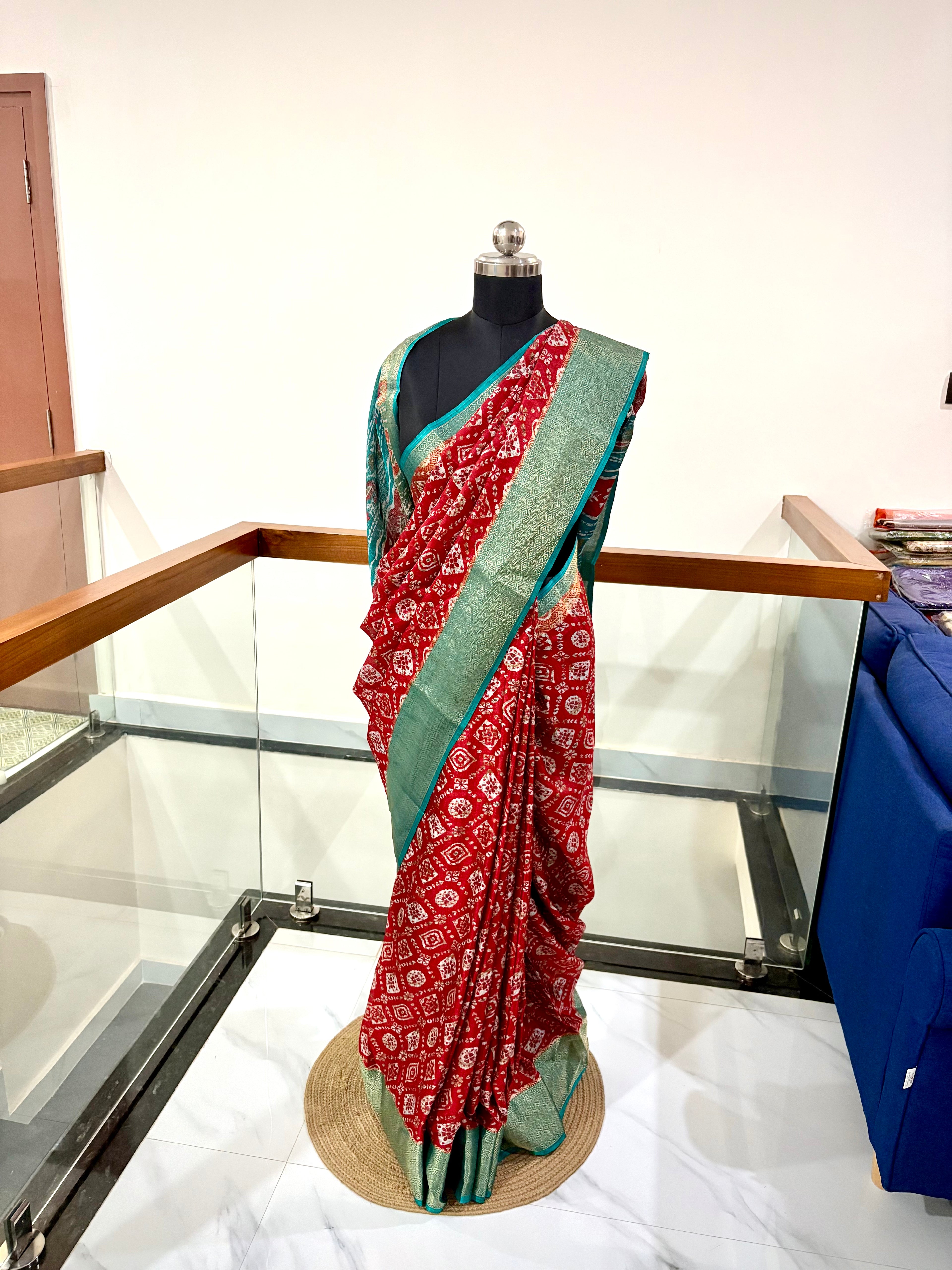 Vibrant Red Saree With Traditional Printed Motifs throughout with Beautiful Mint Green Border Woven Gold Zari Border.
