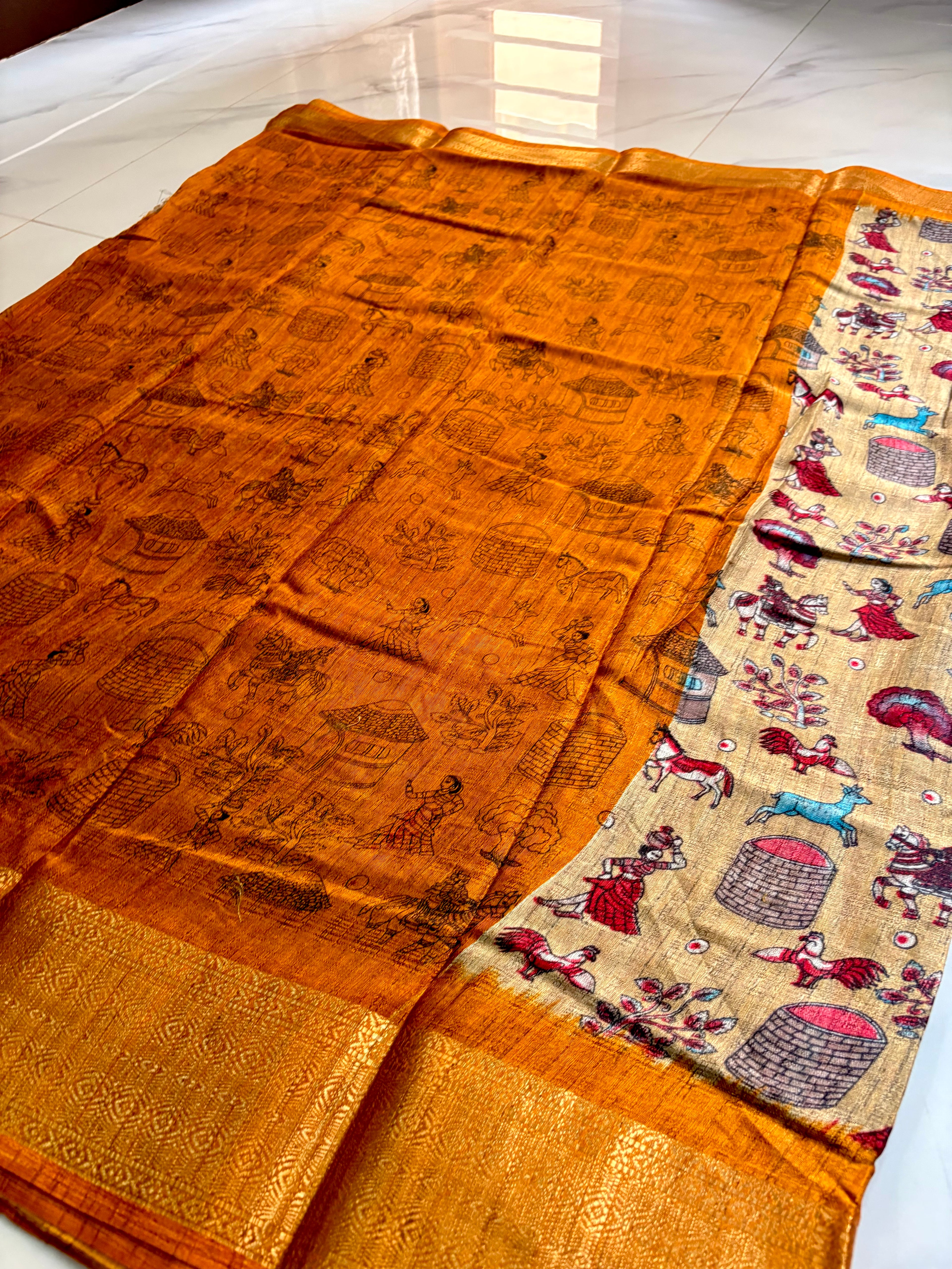 Beautiful Beige Khadi Cotton Saree Featuring vibrant traditional village-life and folk art prints with Rich golden zari woven border