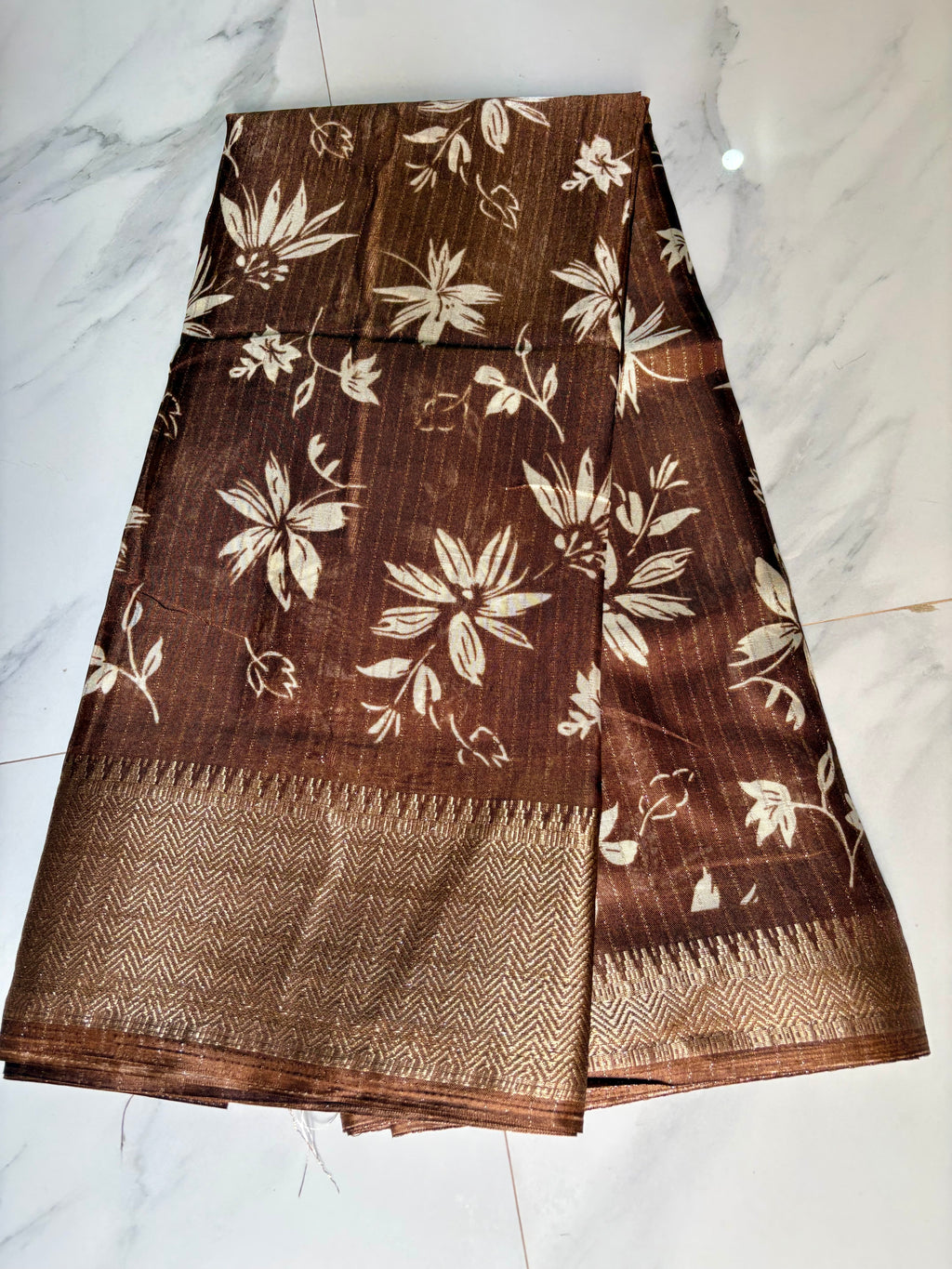 Elegant brown saree adorned with graceful ivory floral prints with Rich zari woven border - Fancy Saree.