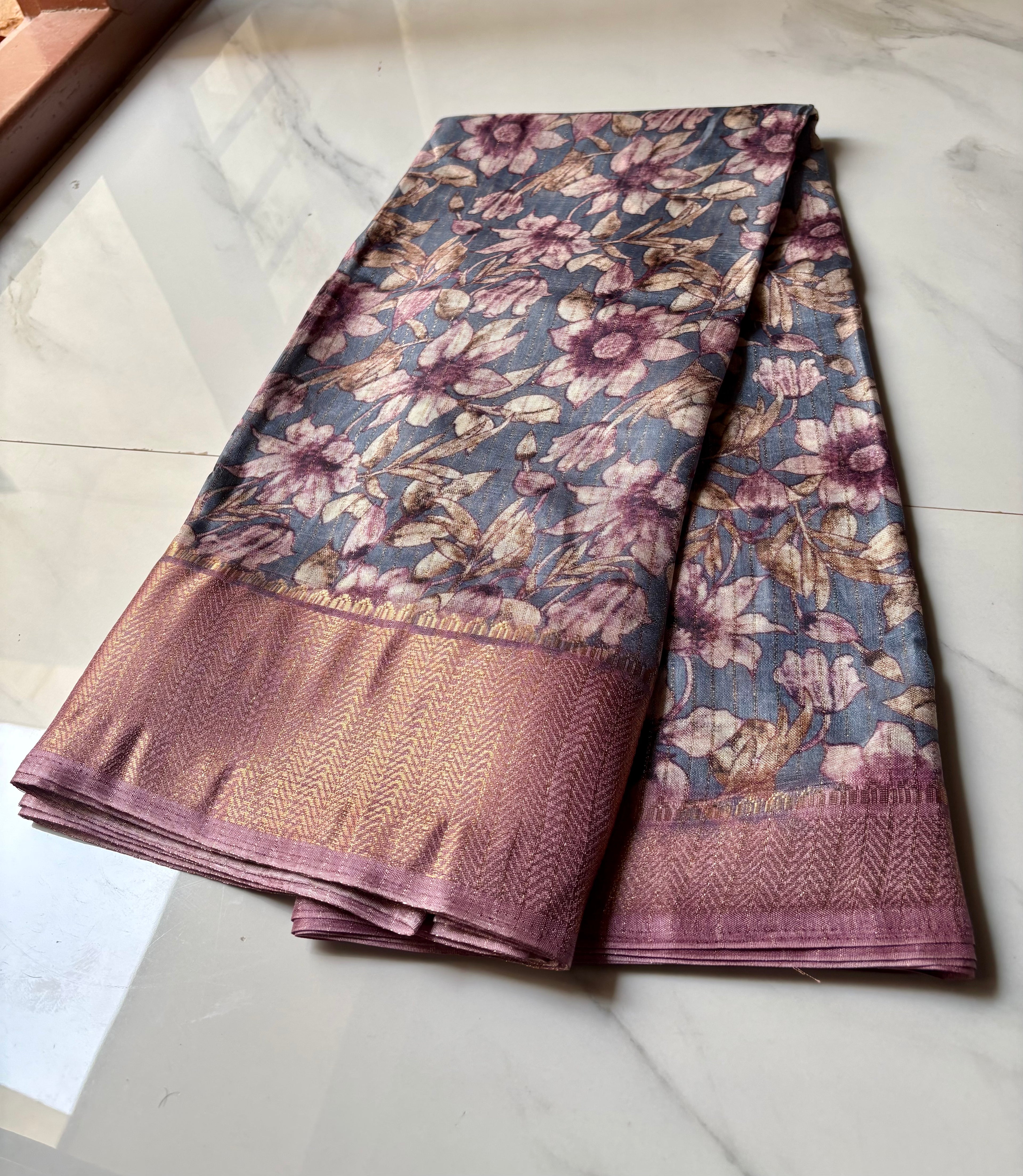Elegant bluish-grey saree featuring graceful floral prints in soft lavender and beige tones with zari woven border - Fancy Saree Cotton Mix Satin Finish.