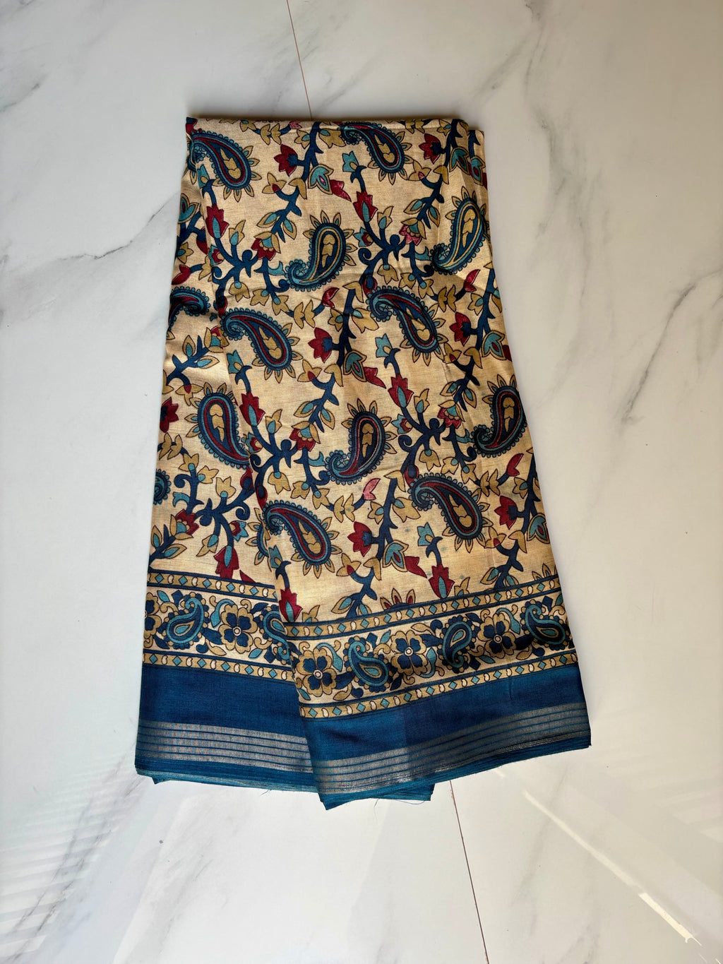 Elegant cream-colored saree featuring beautiful blue paisley and floral prints and silver zari line border - Cotton silk soft Saree