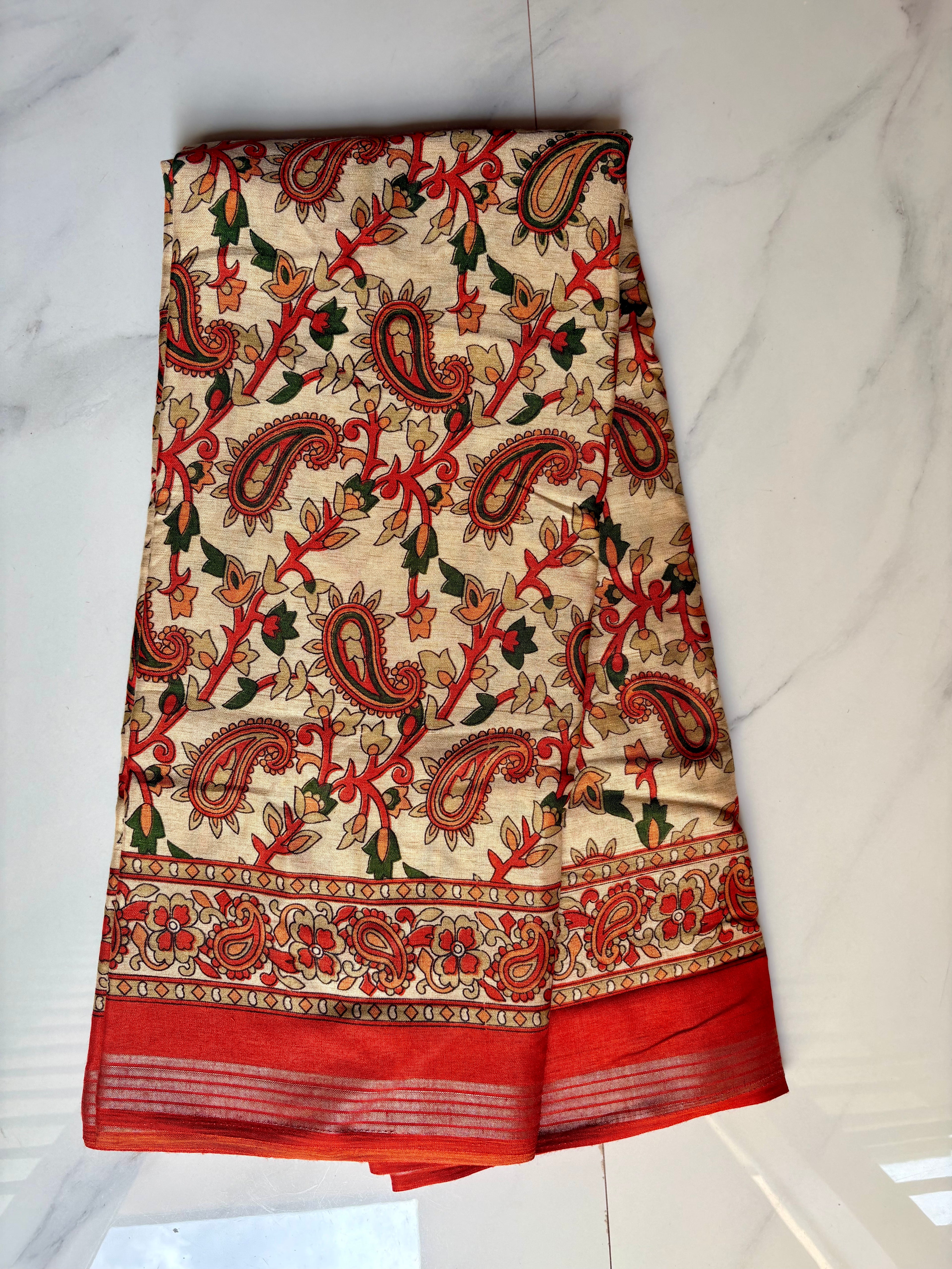 Elegant cream-colored saree featuring beautiful Orange paisley with floral prints and silver zari line border - Cotton silk soft Saree