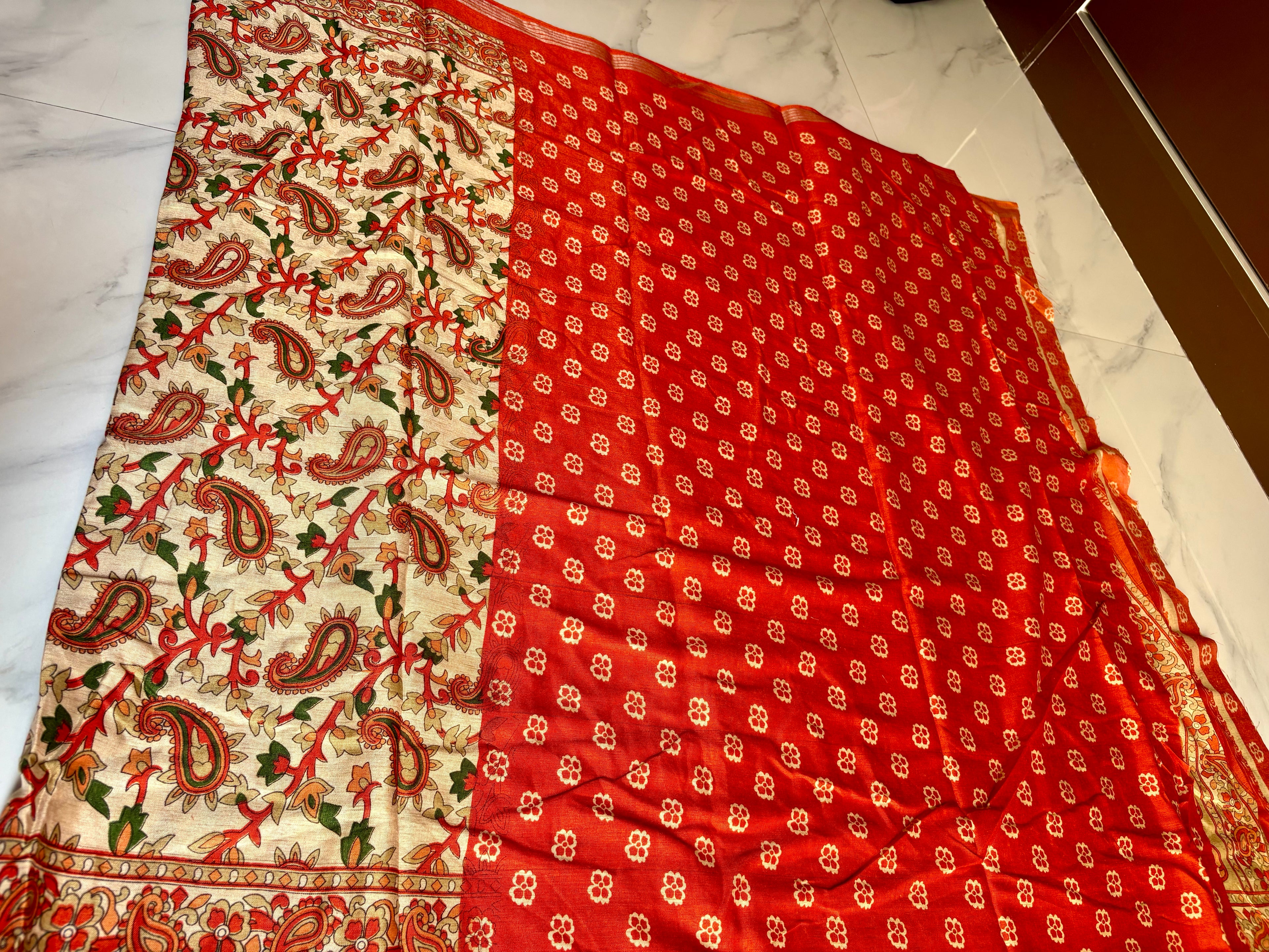 Elegant cream-colored saree featuring beautiful Orange paisley with floral prints and silver zari line border - Cotton silk soft Saree