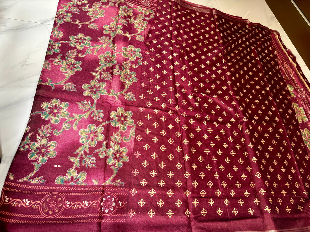 Elegant maroon saree featuring graceful floral vine prints in contrasting green tones and silver zari line border- Cotton silk soft Saree