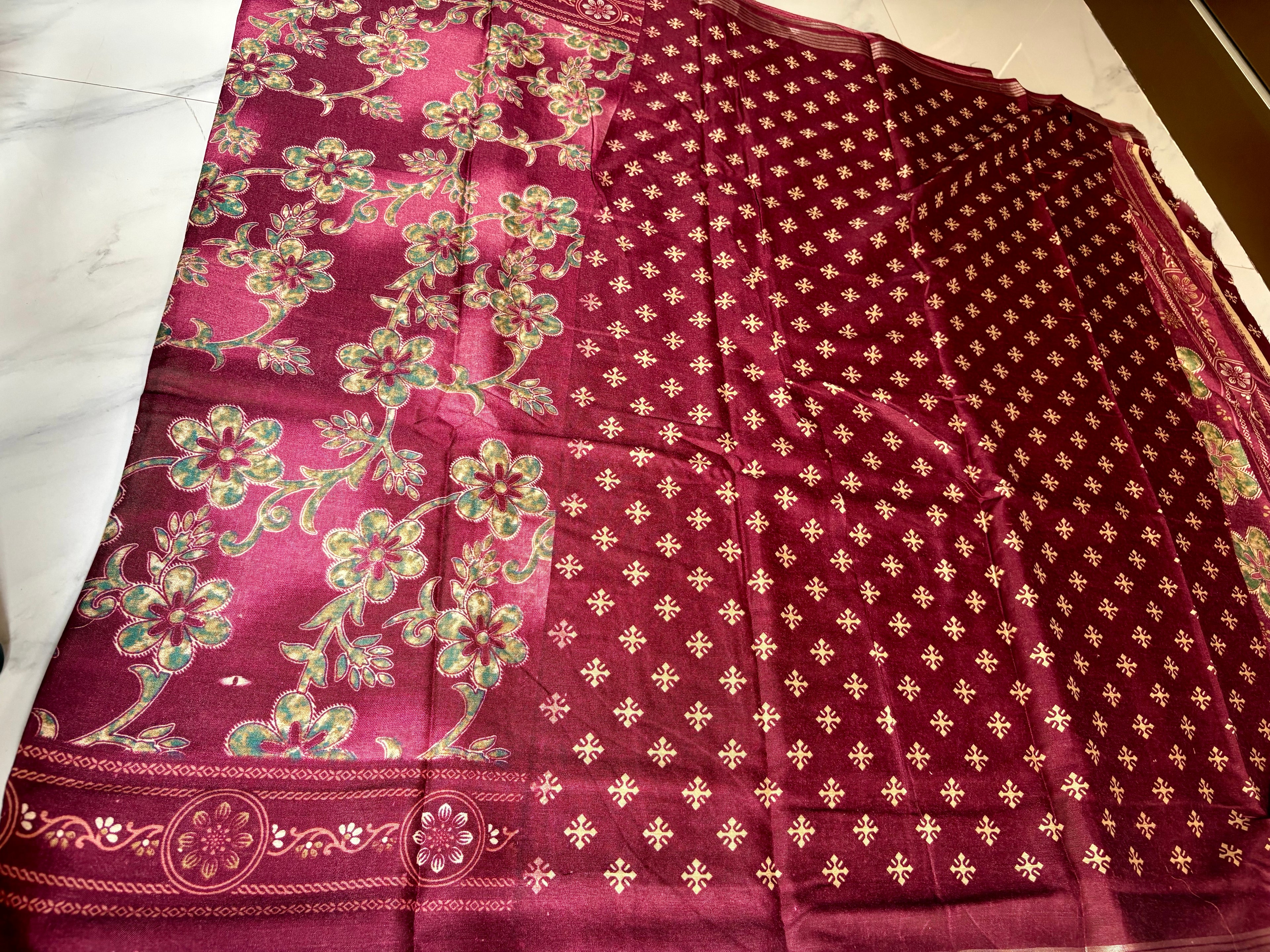 Elegant maroon saree featuring graceful floral vine prints in contrasting green tones and silver zari line border- Cotton silk soft Saree