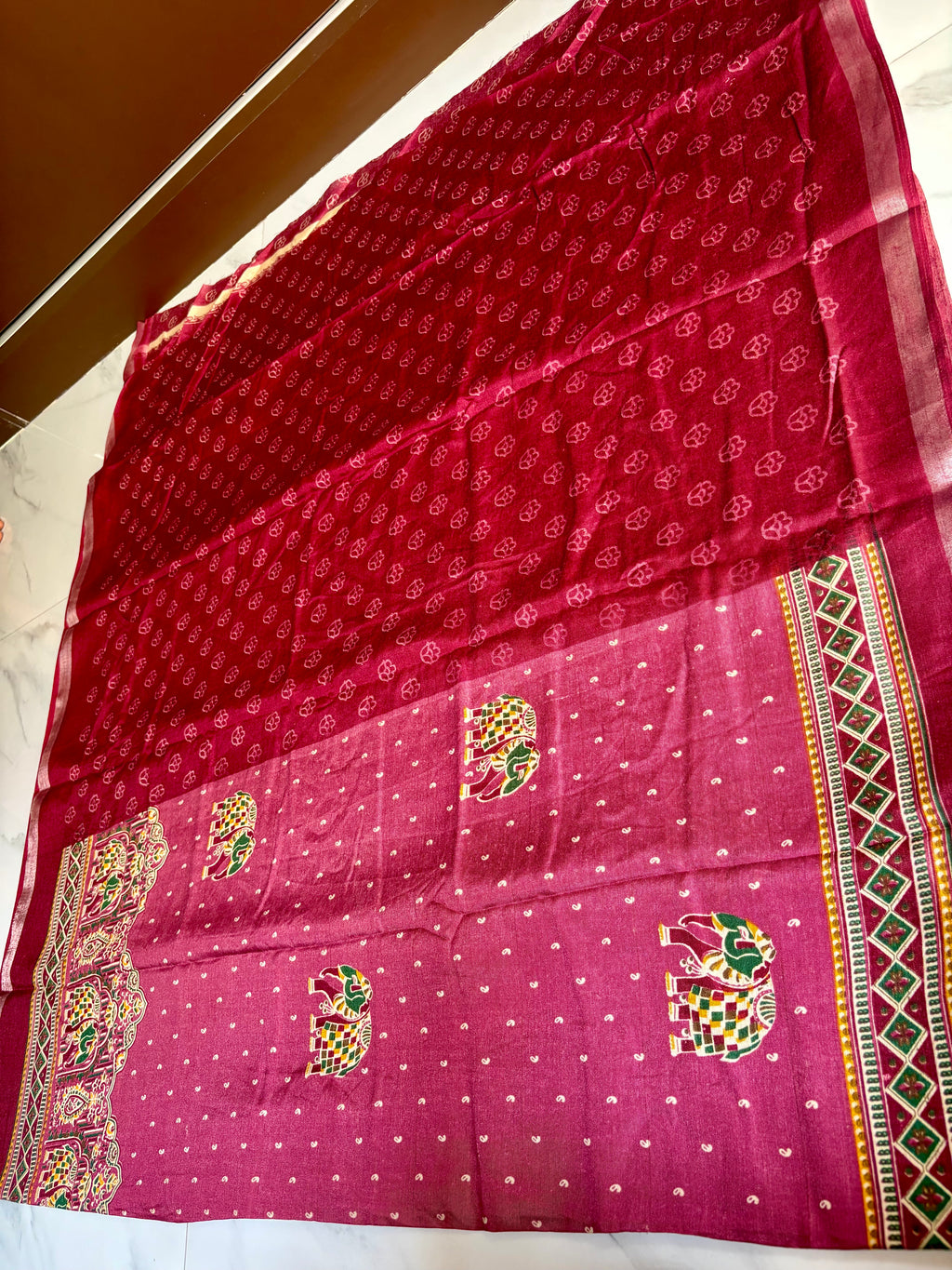 Gracefully designed in a rich maroon -Purple shade, this saree features elegant elephant and heritage-inspired temple motifs Zari Line border- Cotton silk soft Saree