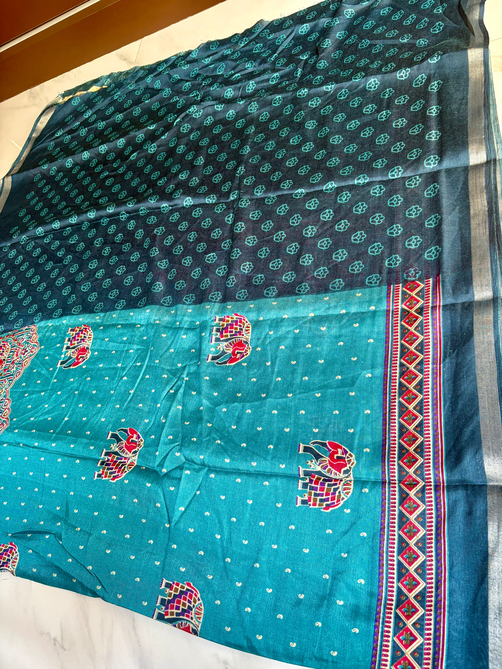 Gracefully designed in a rich Turquoise blue shade, this saree features elegant elephant and heritage-inspired temple motifs Zari Line border- Cotton silk soft Saree