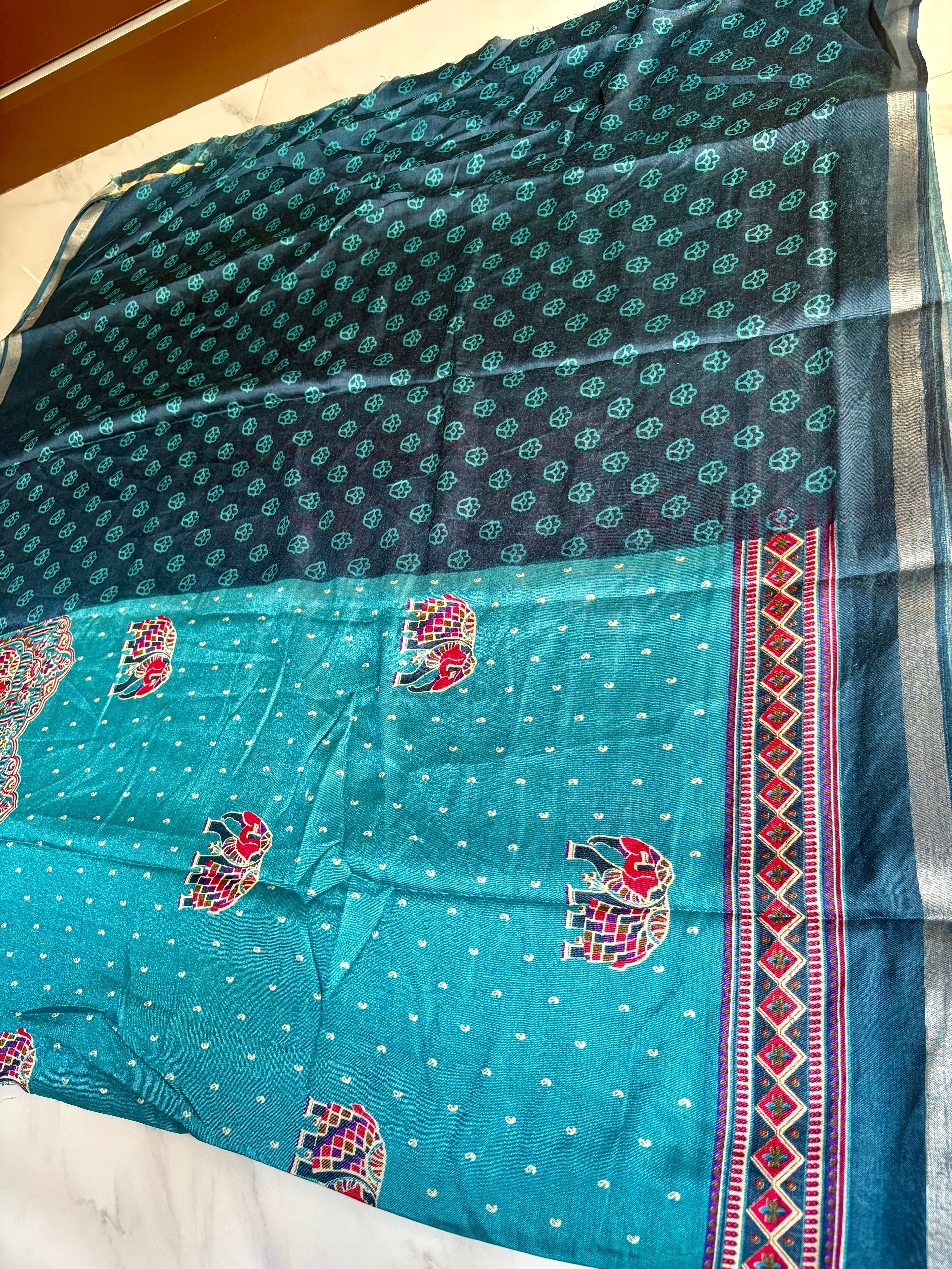 Gracefully designed in a rich Turquoise blue shade, this saree features elegant elephant and heritage-inspired temple motifs Zari Line border- Cotton silk soft Saree