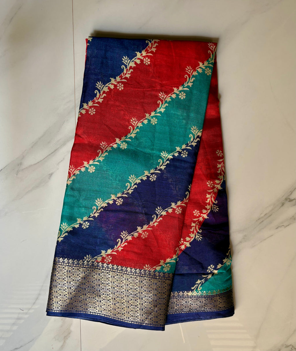 Elegant multicolor saree featuring vibrant diagonal stripes in red, teal, and navy blue, and a rich zari border- Cotton tissue soft Saree