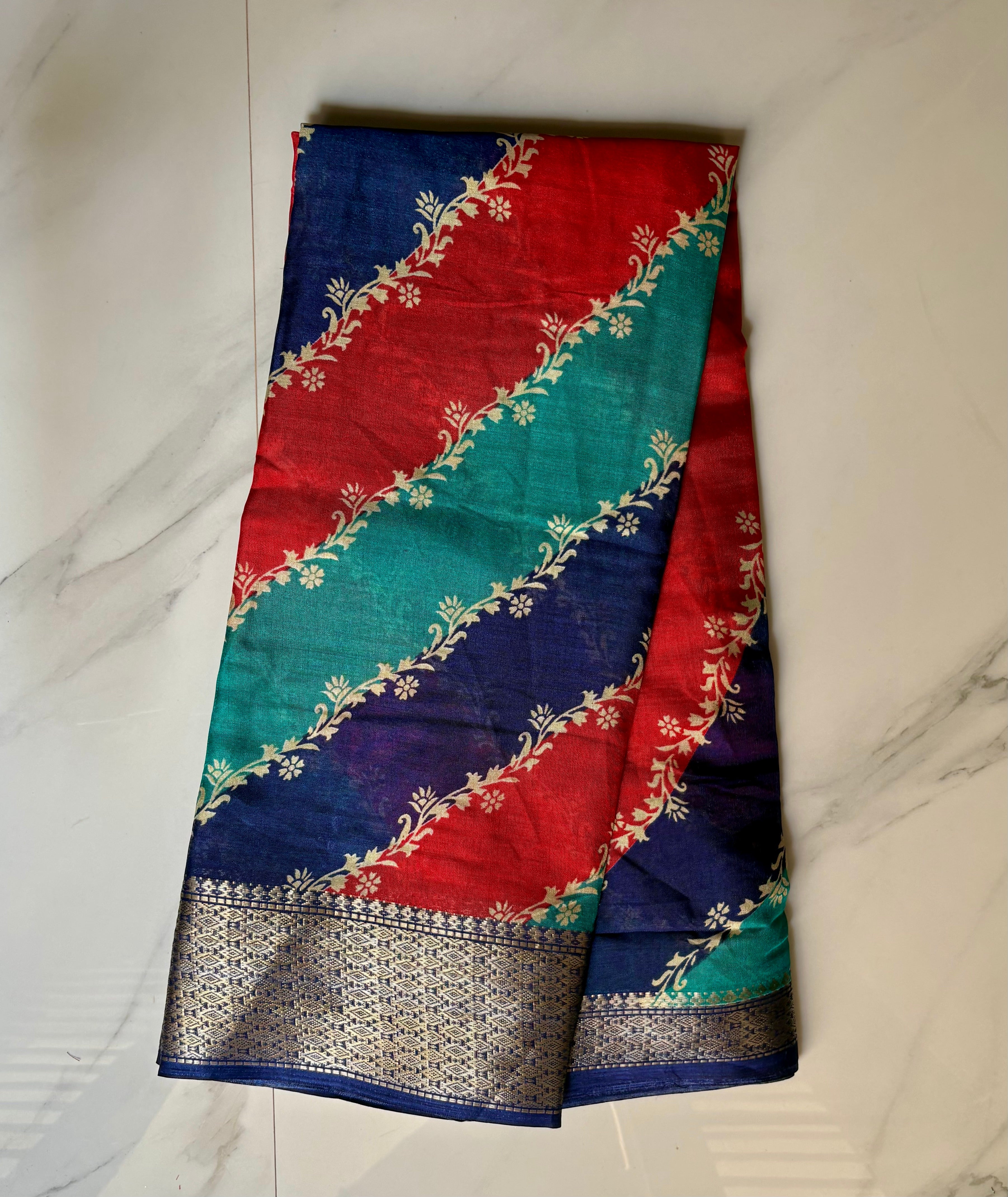 Elegant multicolor saree featuring vibrant diagonal stripes in red, teal, and navy blue, and a rich zari border- Cotton tissue soft Saree