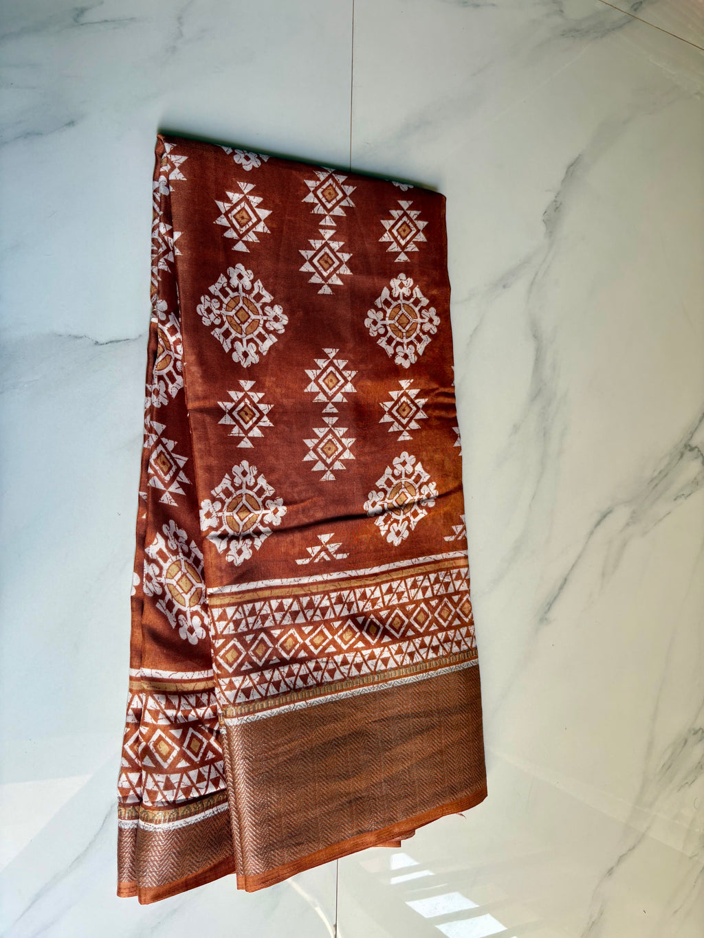 Elegant brown saree featuring beautiful white geometric and floral motifs and a shimmering silver zari border- Cotton tissue soft Saree