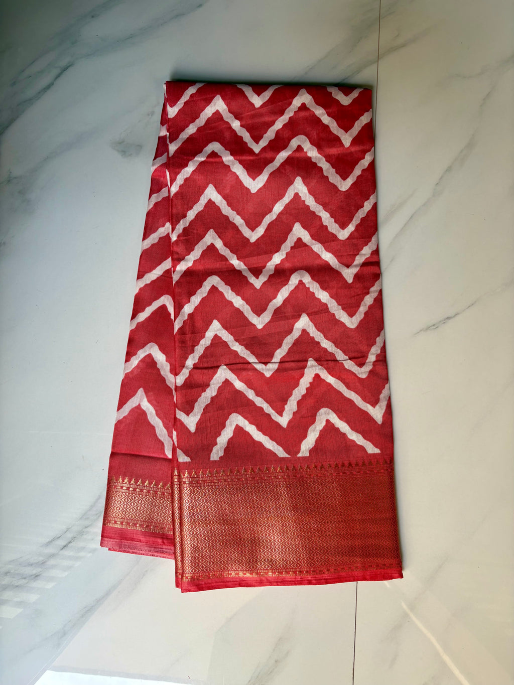Stunning red saree featuring bold white zigzag patterns and golden border- Cotton tissue soft Saree