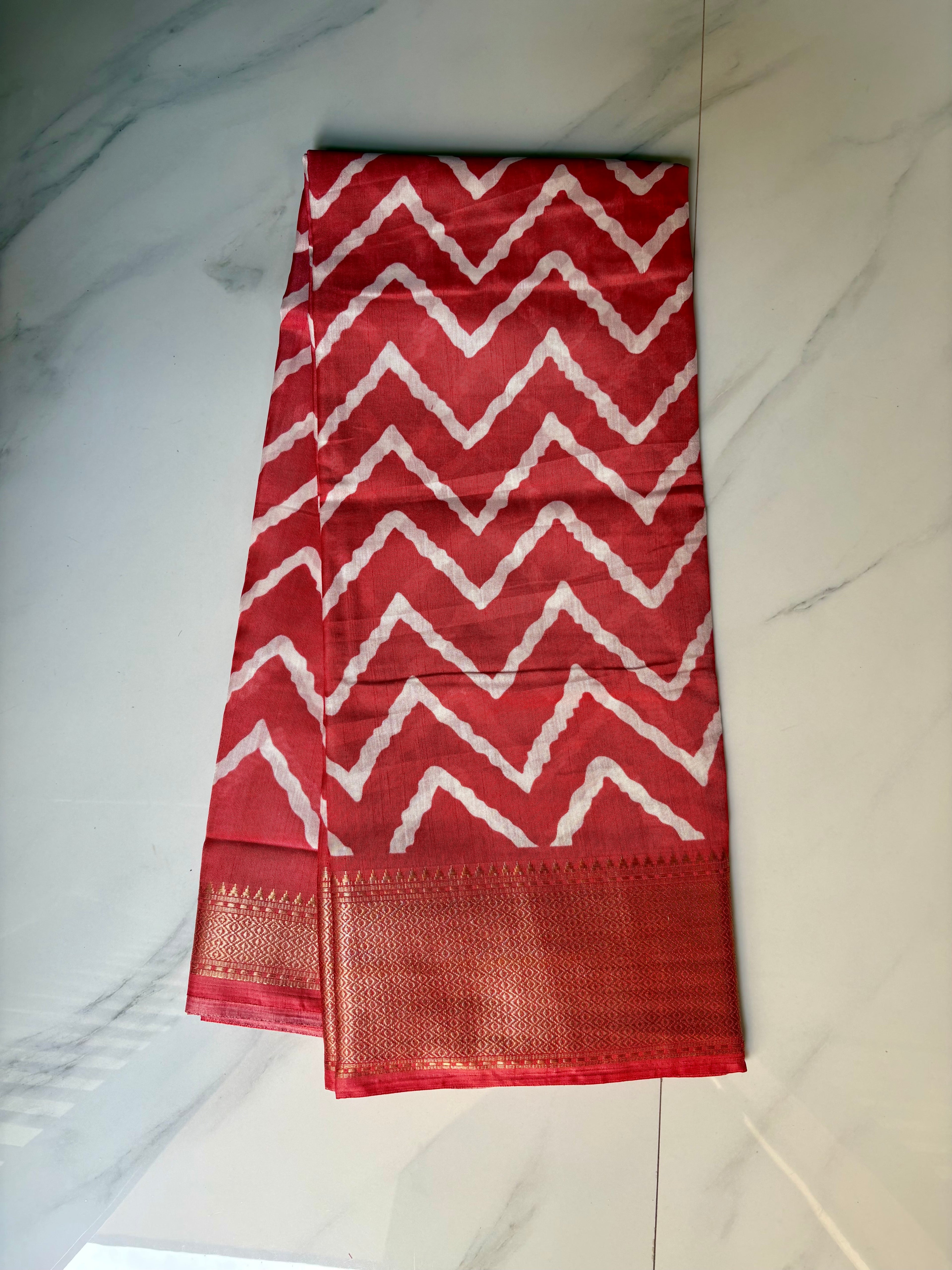Stunning red saree featuring bold white zigzag patterns and golden border- Cotton tissue soft Saree
