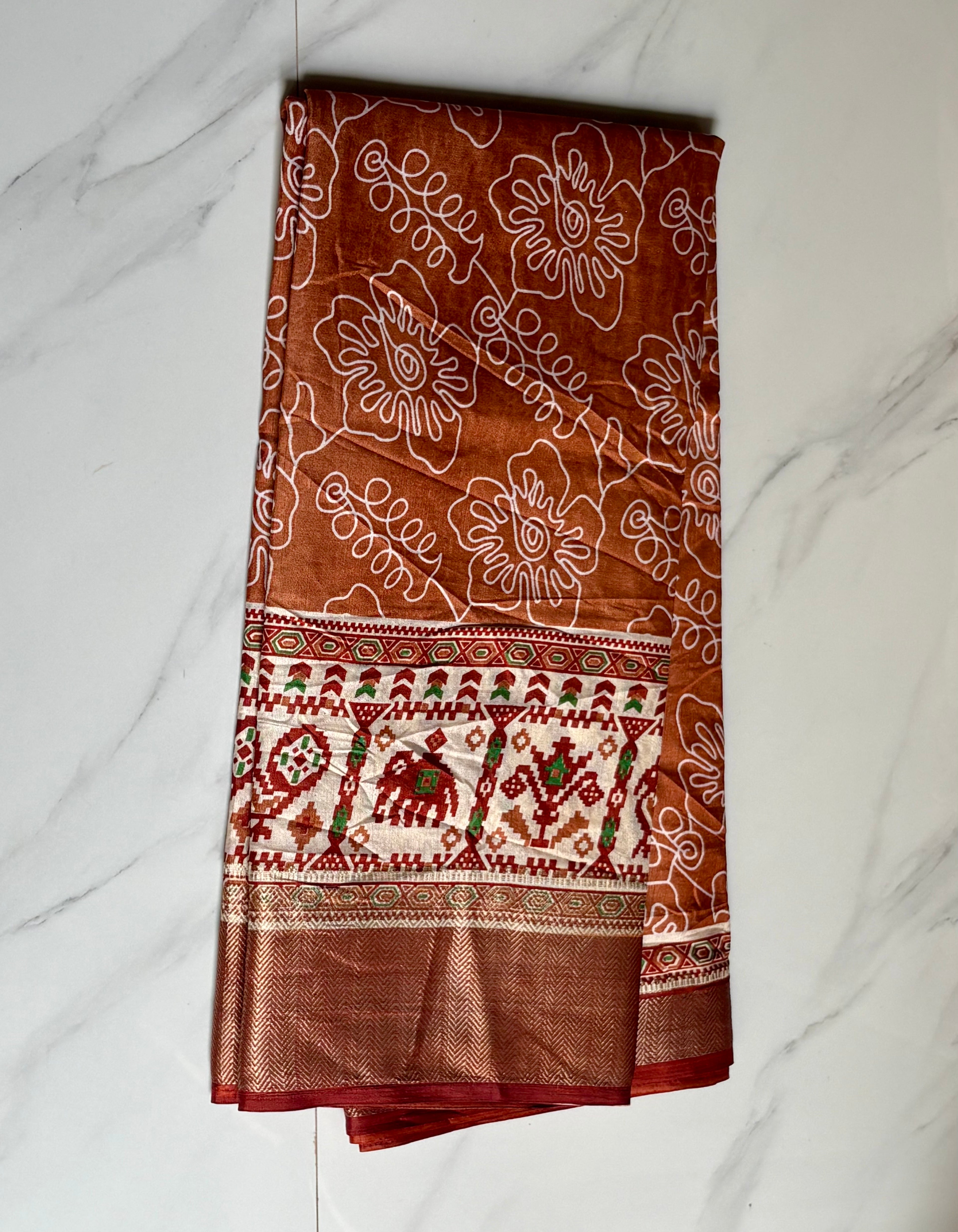 Elegant rust brown saree featuring artistic white floral line prints with a ethnic border inspired by traditional motifs - Cotton tissue soft Saree