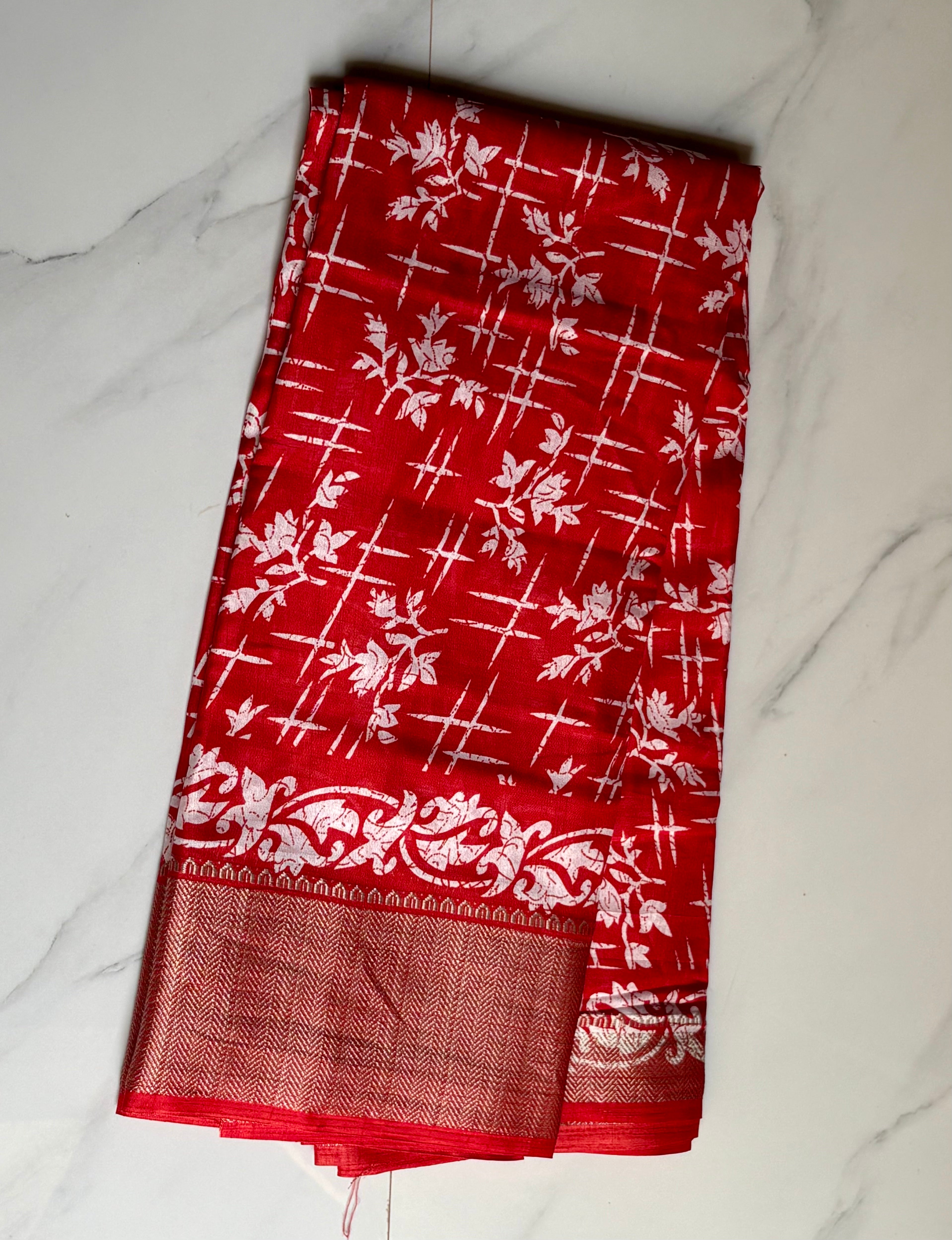 Elegant red saree adorned with charming white floral and abstract prints, complemented by a rich zari border - Cotton tissue soft Saree