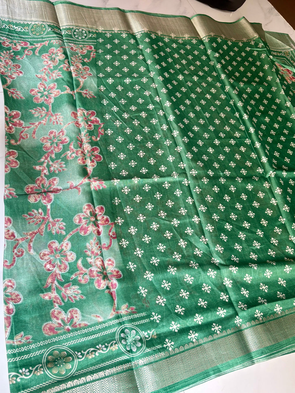 Elegant green floral print saree, beautifully adorned with blooming floral motifs and a shimmering silver zari border- Cotton tissue soft Saree
