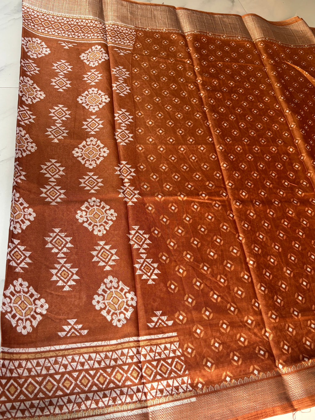 Elegant brown saree featuring beautiful white geometric and floral motifs and a shimmering silver zari border- Cotton tissue soft Saree