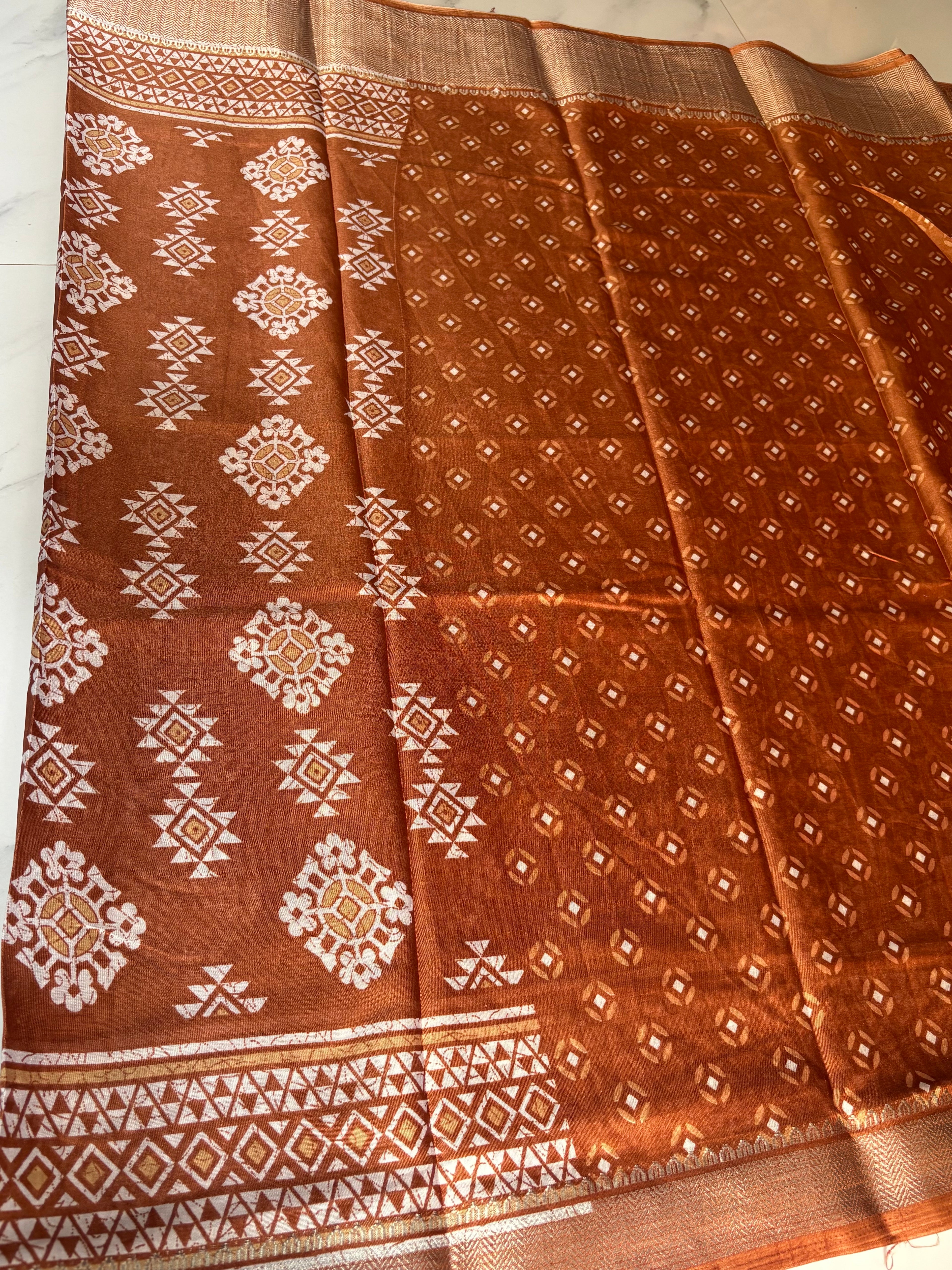 Elegant brown saree featuring beautiful white geometric and floral motifs and a shimmering silver zari border- Cotton tissue soft Saree