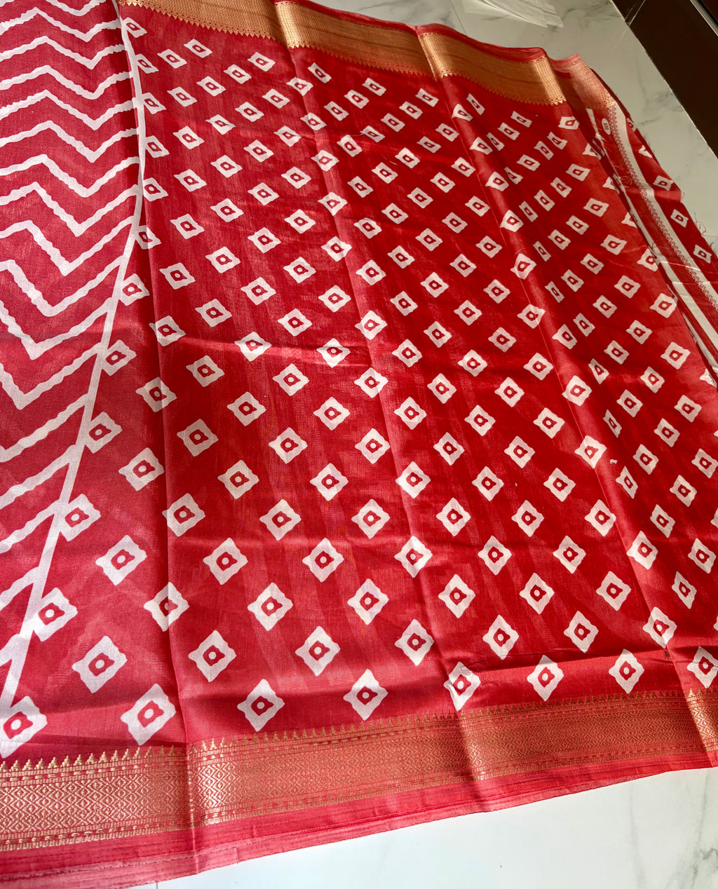 Stunning red saree featuring bold white zigzag patterns and golden border- Cotton tissue soft Saree