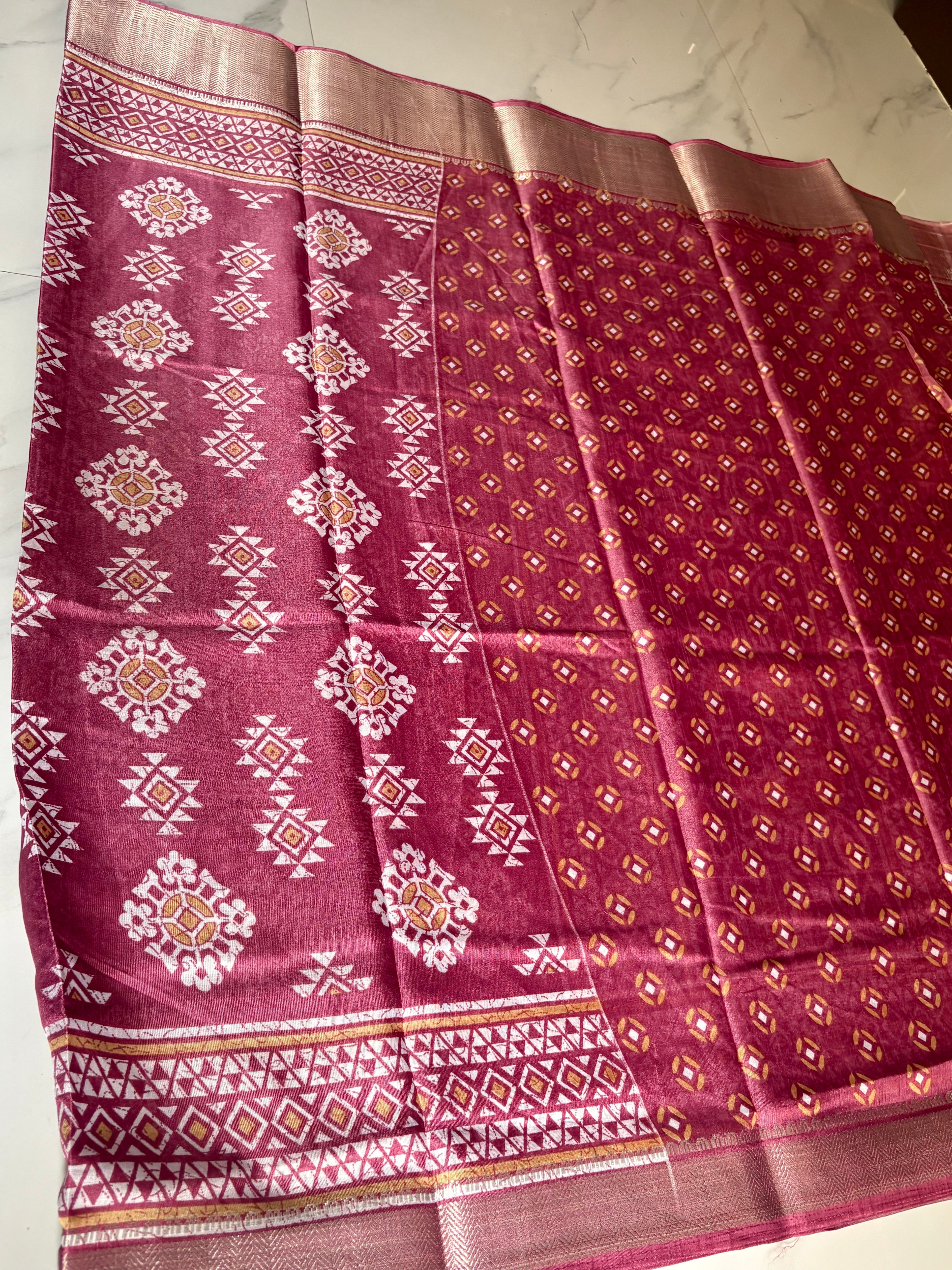 Elegant mauve printed saree, featuring beautiful geometric and floral-inspired motifs complemented by a rich zari border- Cotton tissue soft Saree