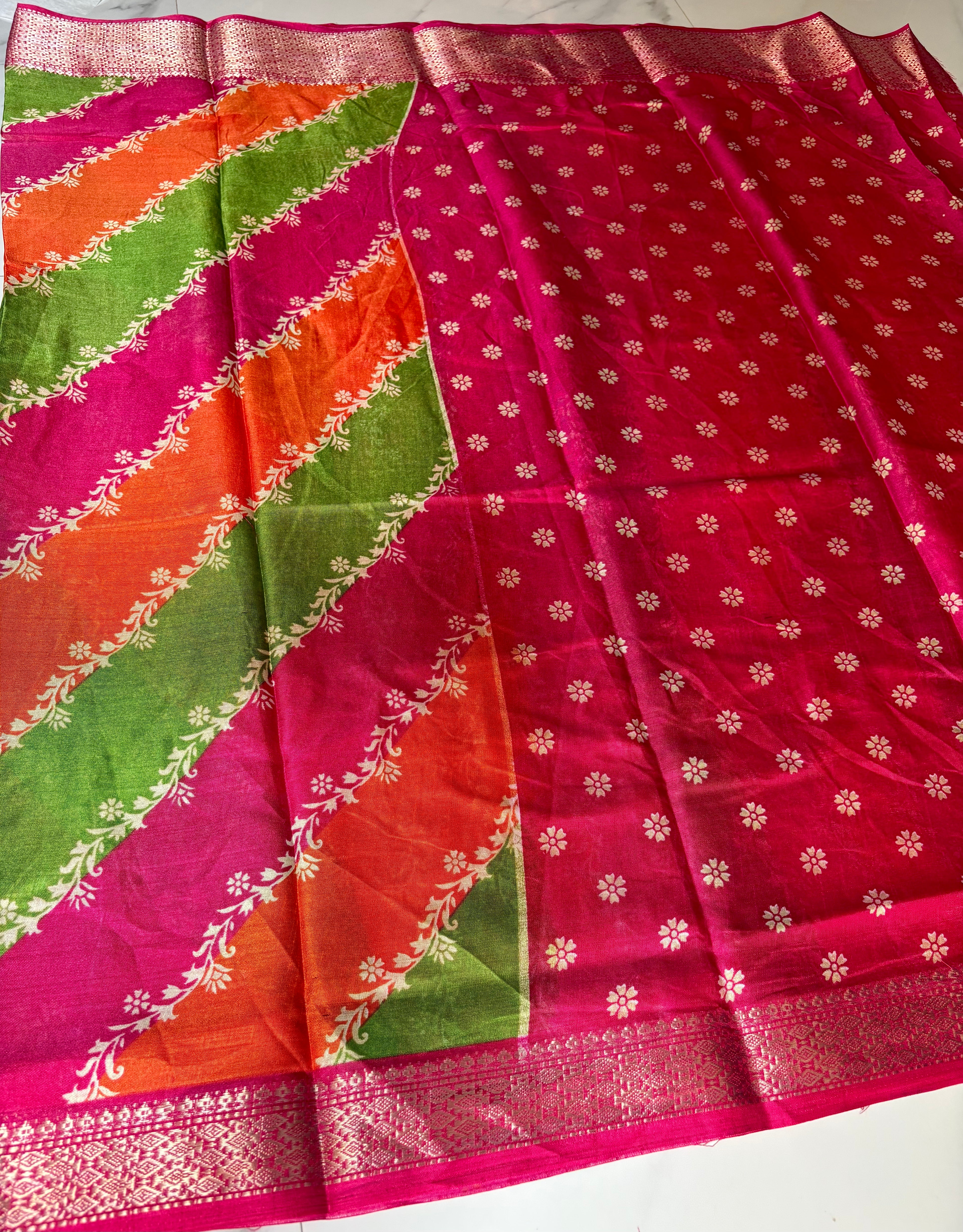Graceful multicolor saree featuring striking diagonal panels in pink, green, and orange, beautifully accented with delicate floral vine prints with an elegant zari border - Cotton tissue soft Saree