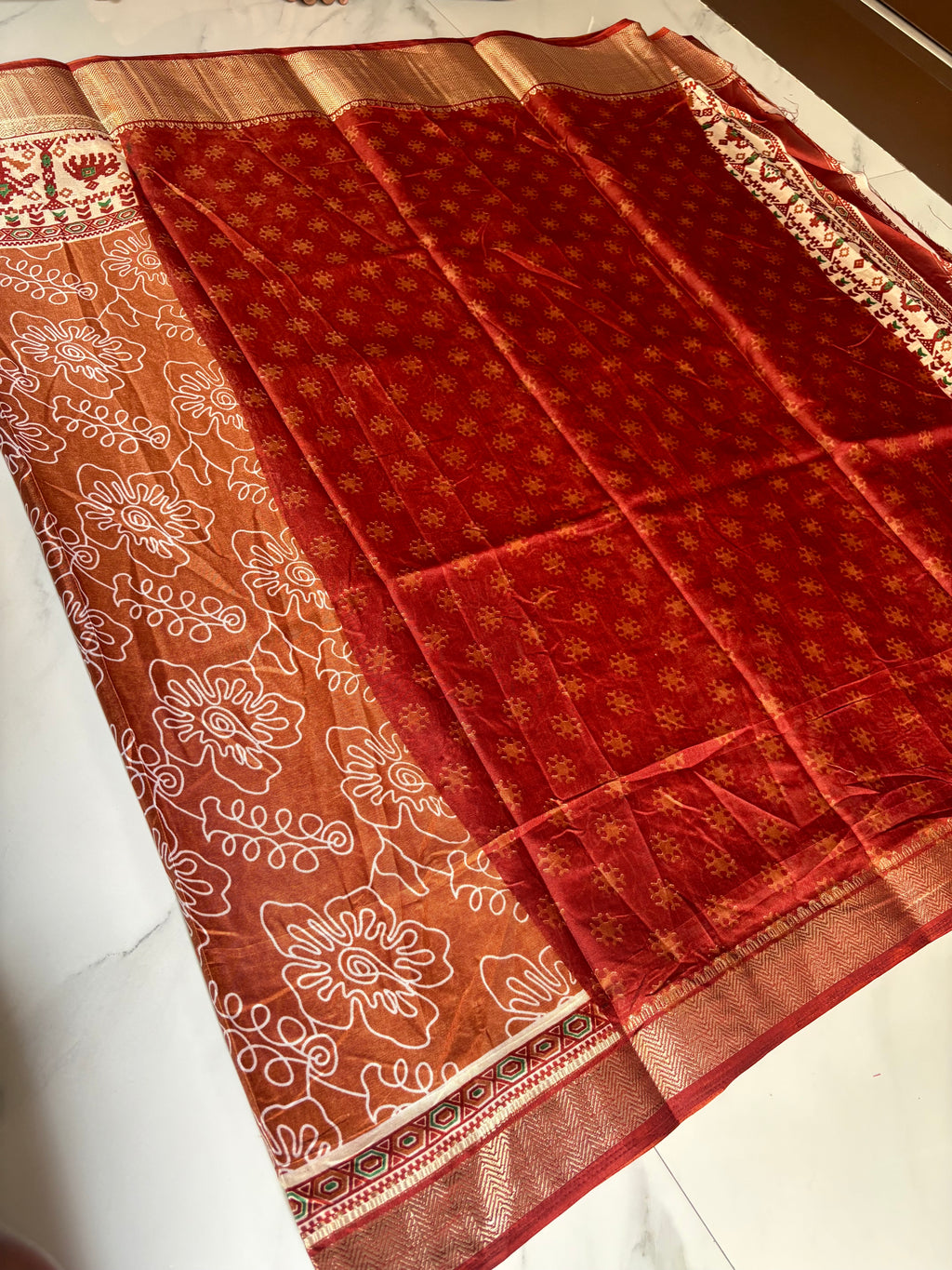 Elegant rust brown saree featuring artistic white floral line prints with a ethnic border inspired by traditional motifs - Cotton tissue soft Saree