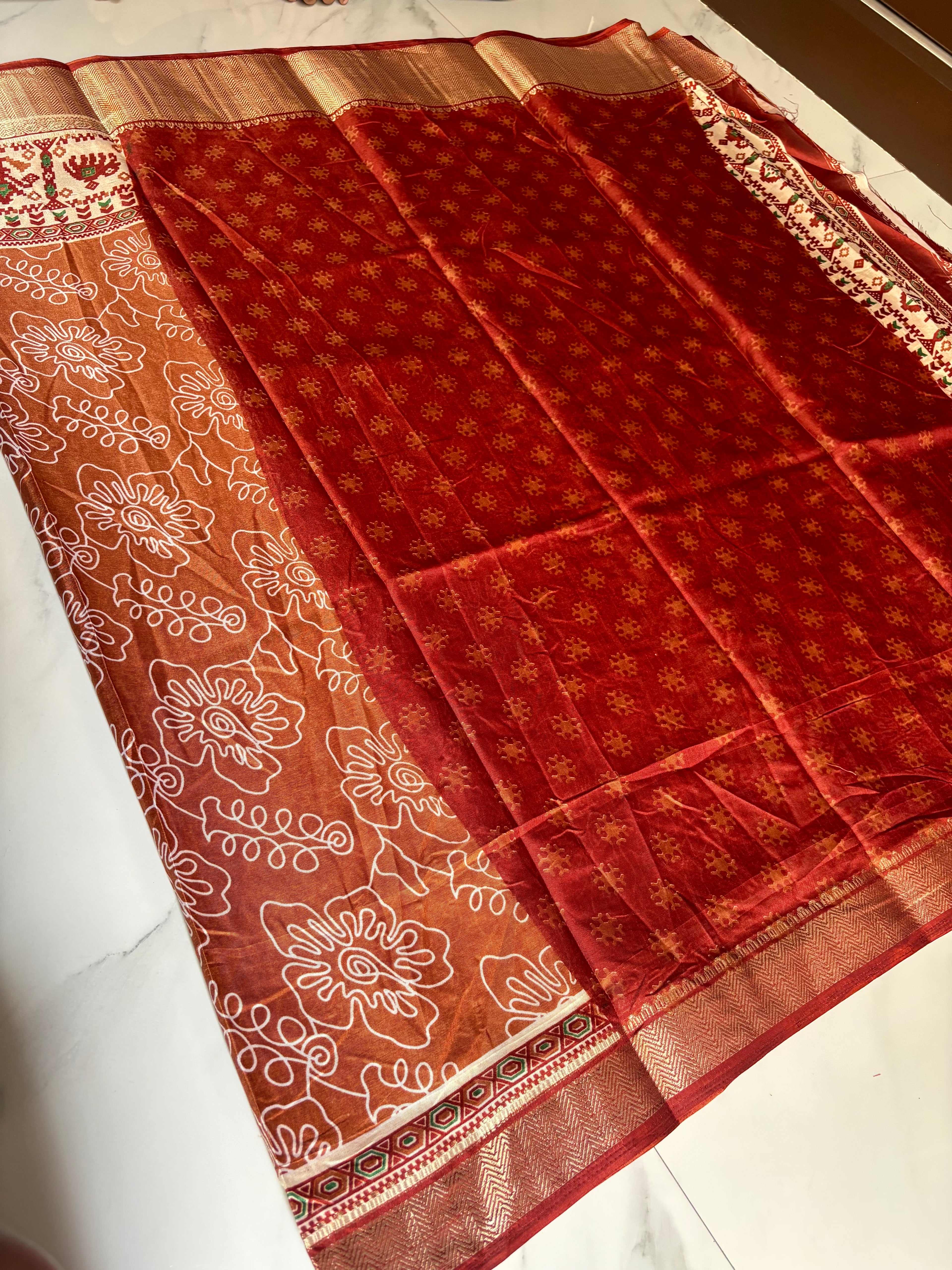 Elegant rust brown saree featuring artistic white floral line prints with a ethnic border inspired by traditional motifs - Cotton tissue soft Saree