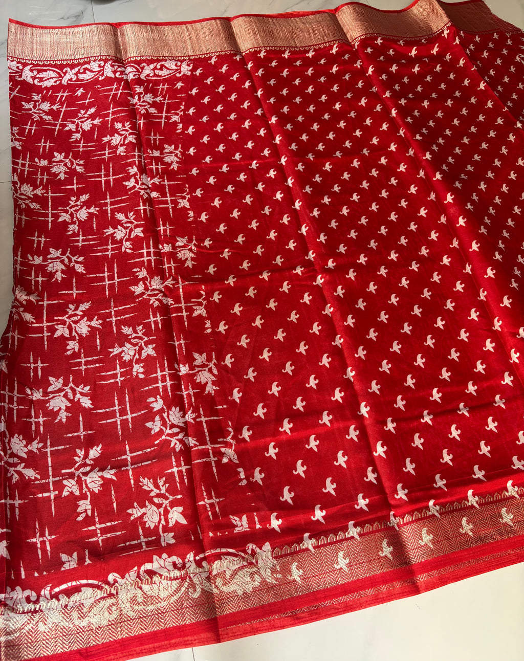 Elegant red saree adorned with charming white floral and abstract prints, complemented by a rich zari border - Cotton tissue soft Saree