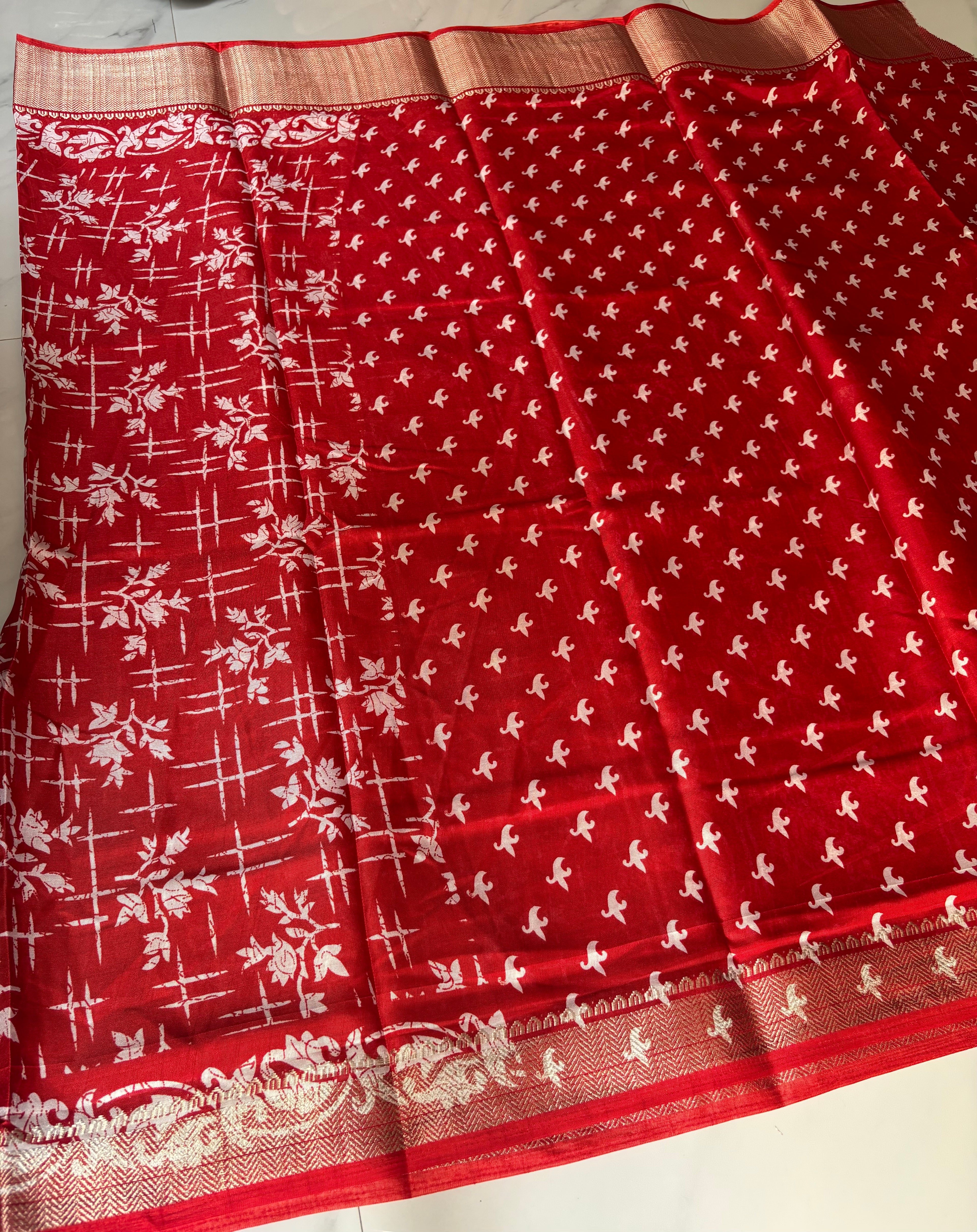 Elegant red saree adorned with charming white floral and abstract prints, complemented by a rich zari border - Cotton tissue soft Saree