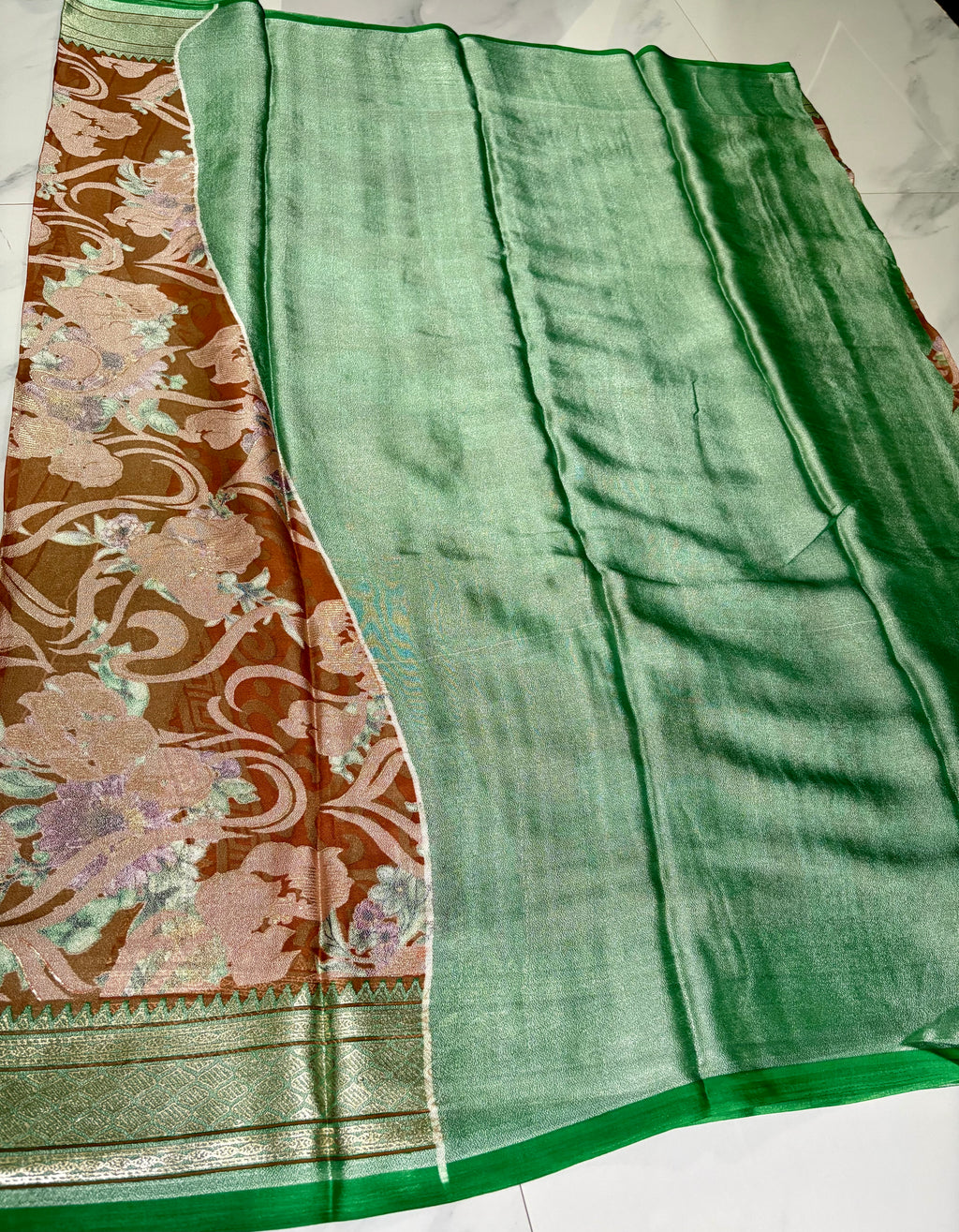 Elegant light brown floral printed saree, featuring a graceful blend of soft pastel blooms and flowing vine patterns with Zari Border - organza georgette blend saree