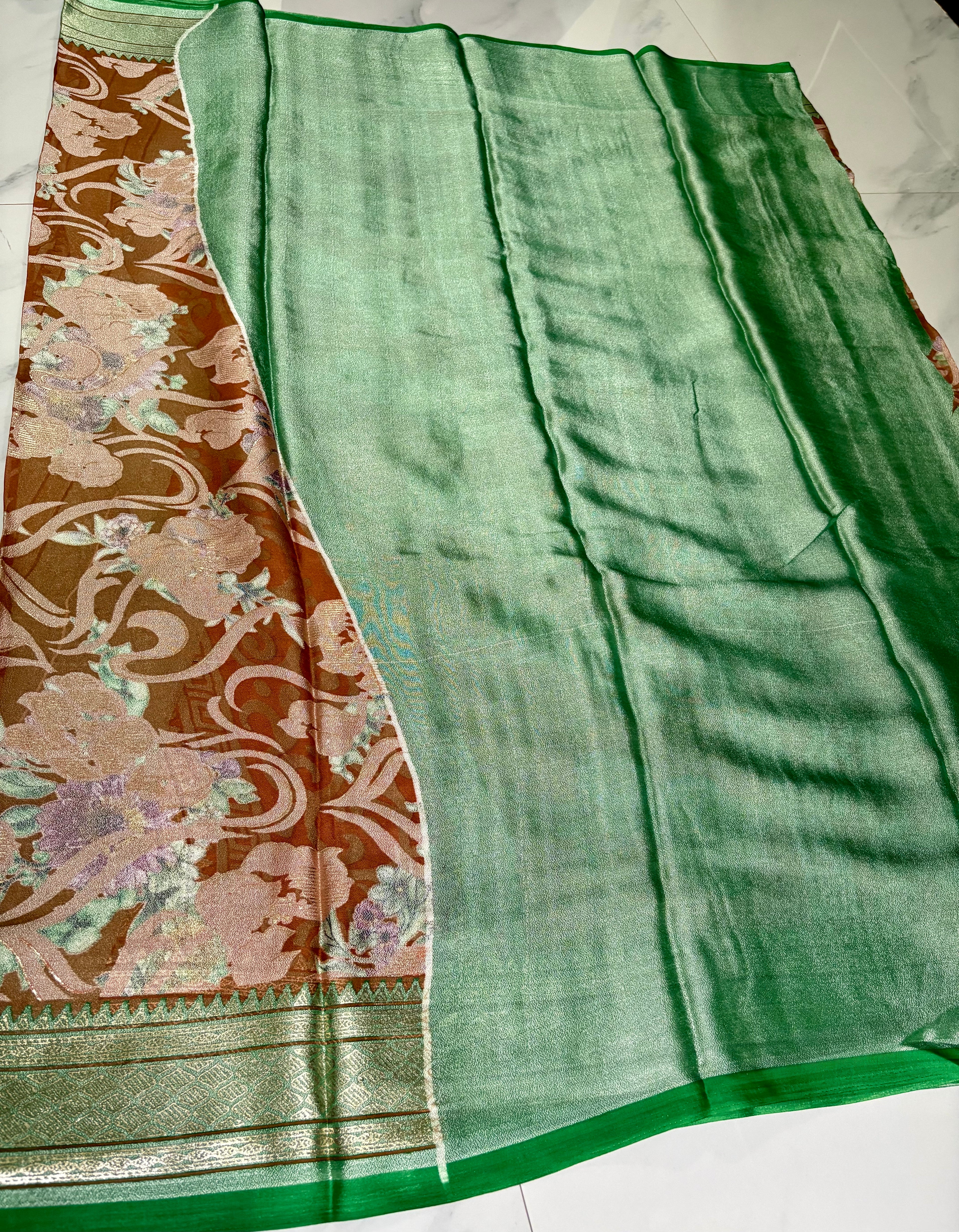 Elegant light brown floral printed saree, featuring a graceful blend of soft pastel blooms and flowing vine patterns with Zari Border - organza georgette blend saree