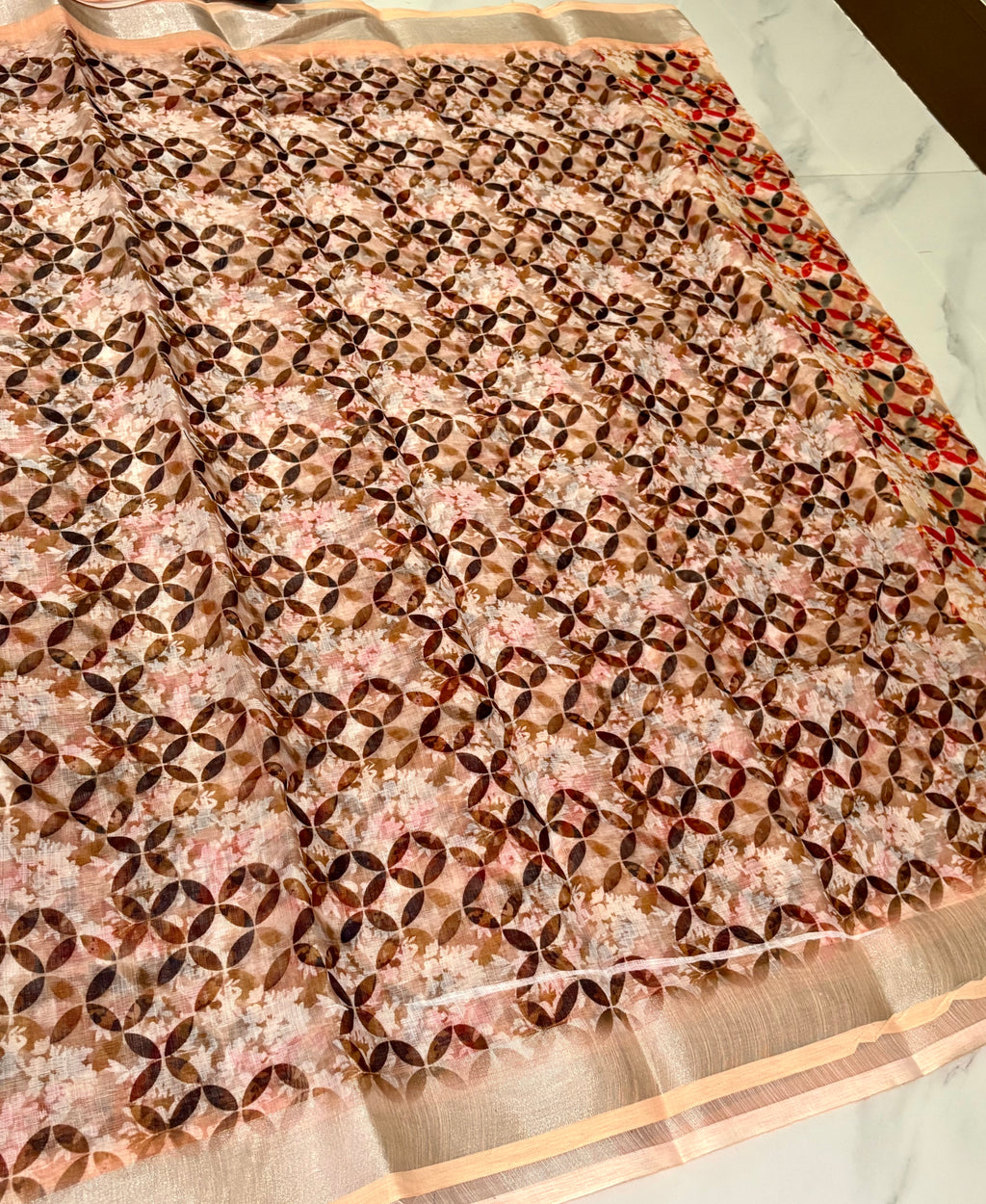 Elegant beautiful printed saree featuring a modern geometric floral pattern in warm shades of red, peach, brown, and black - Cotton Saree