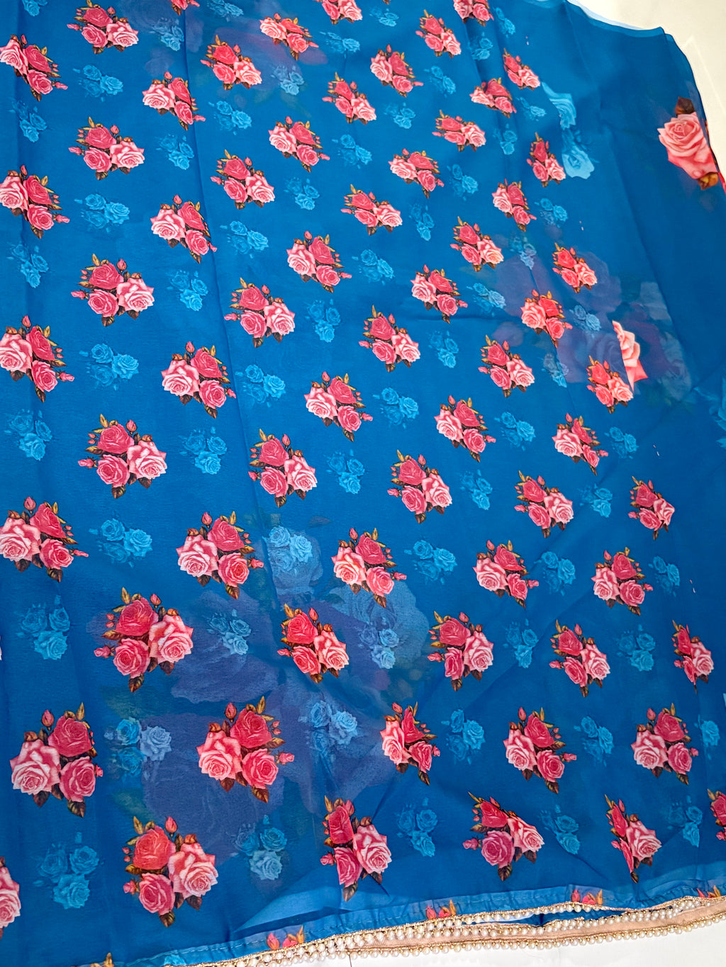 elegant royal blue saree featuring graceful floral rose prints in contrasting shades and Pearl Border- Chiffon Saree