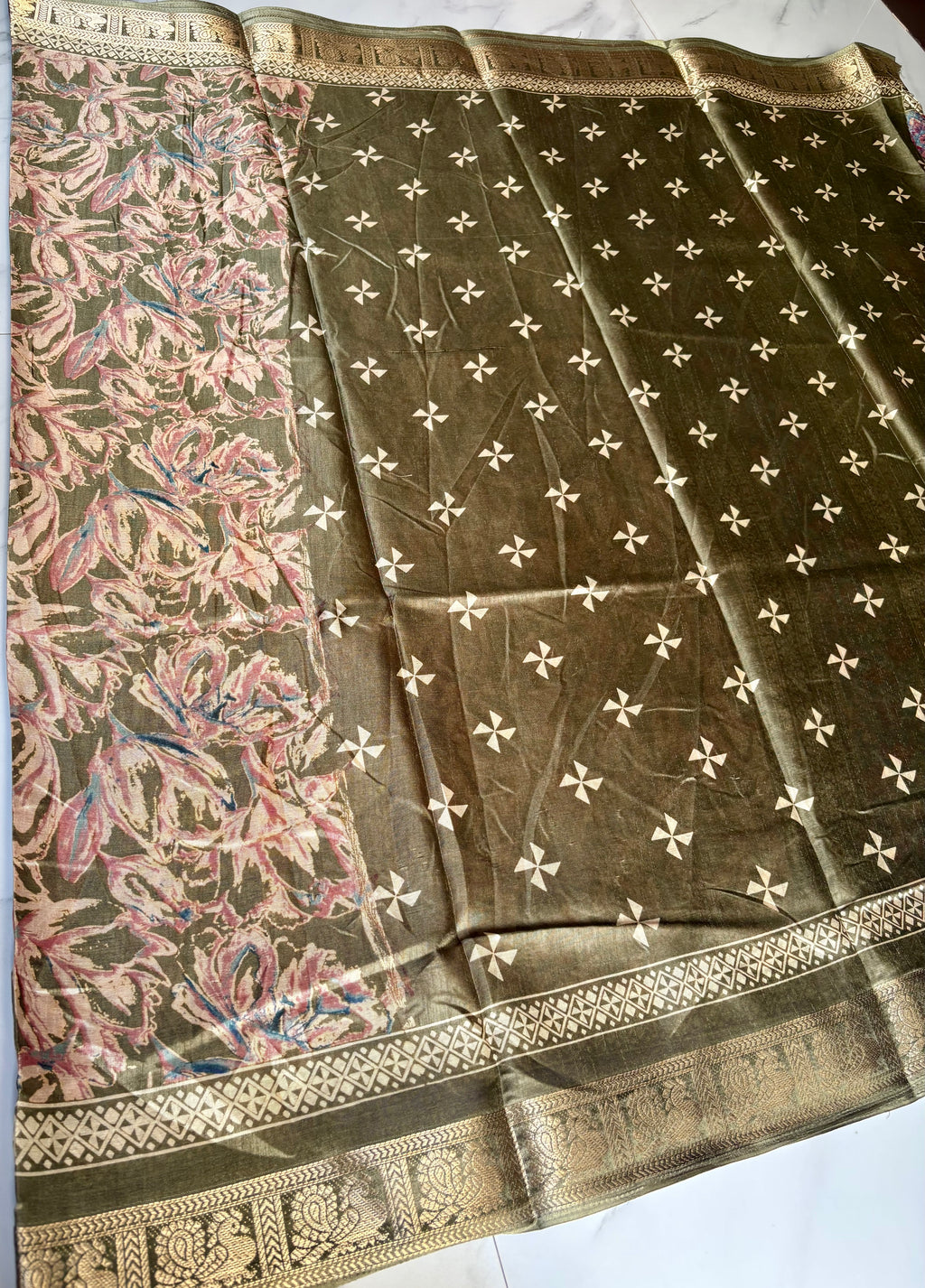 Elegant olive green saree featuring an all-over floral print in soft pink and beige tones, beautifully complemented by a rich golden woven border. - Satin Tissue Saree