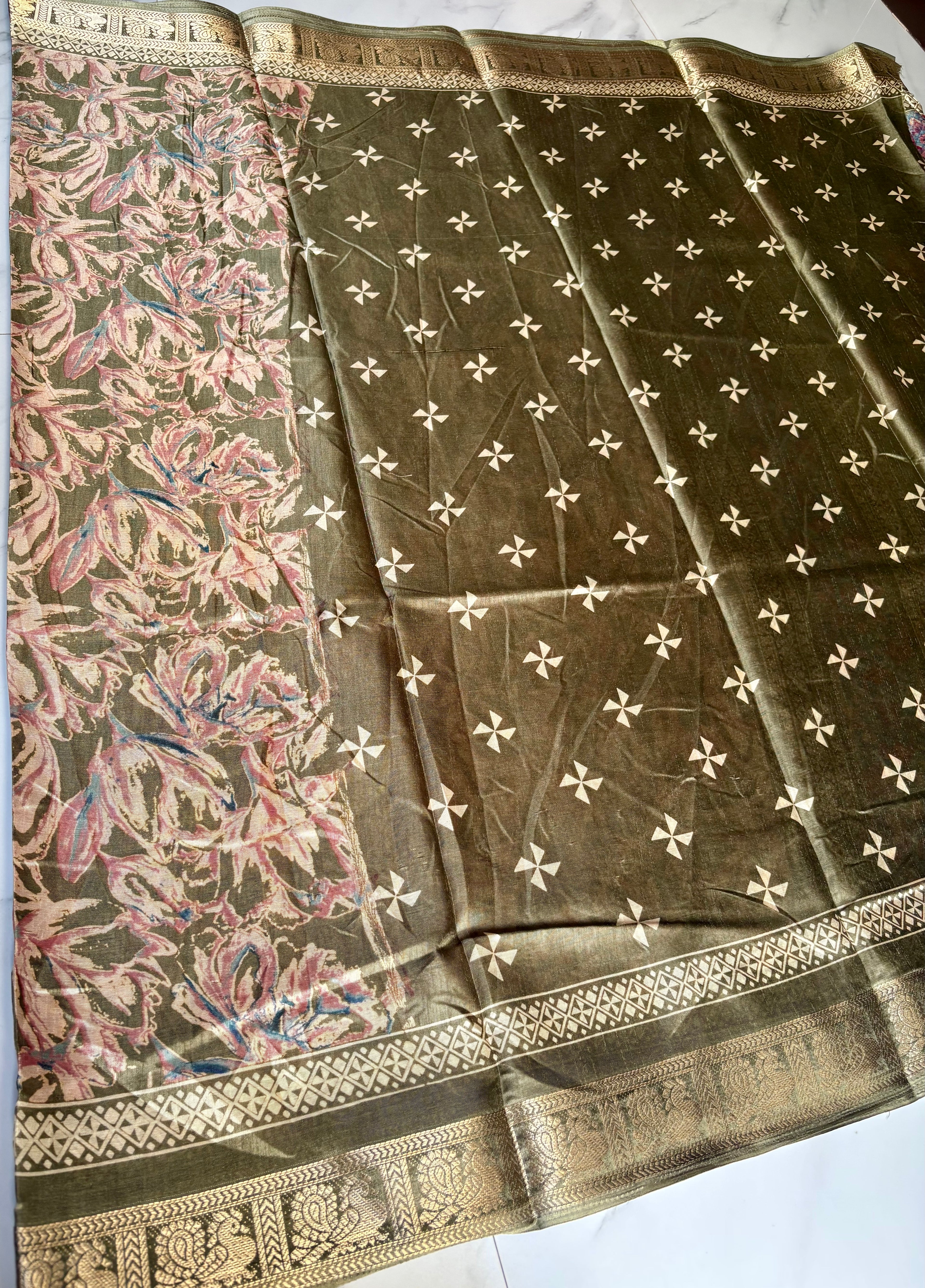Elegant olive green saree featuring an all-over floral print in soft pink and beige tones, beautifully complemented by a rich golden woven border. - Satin Tissue Saree