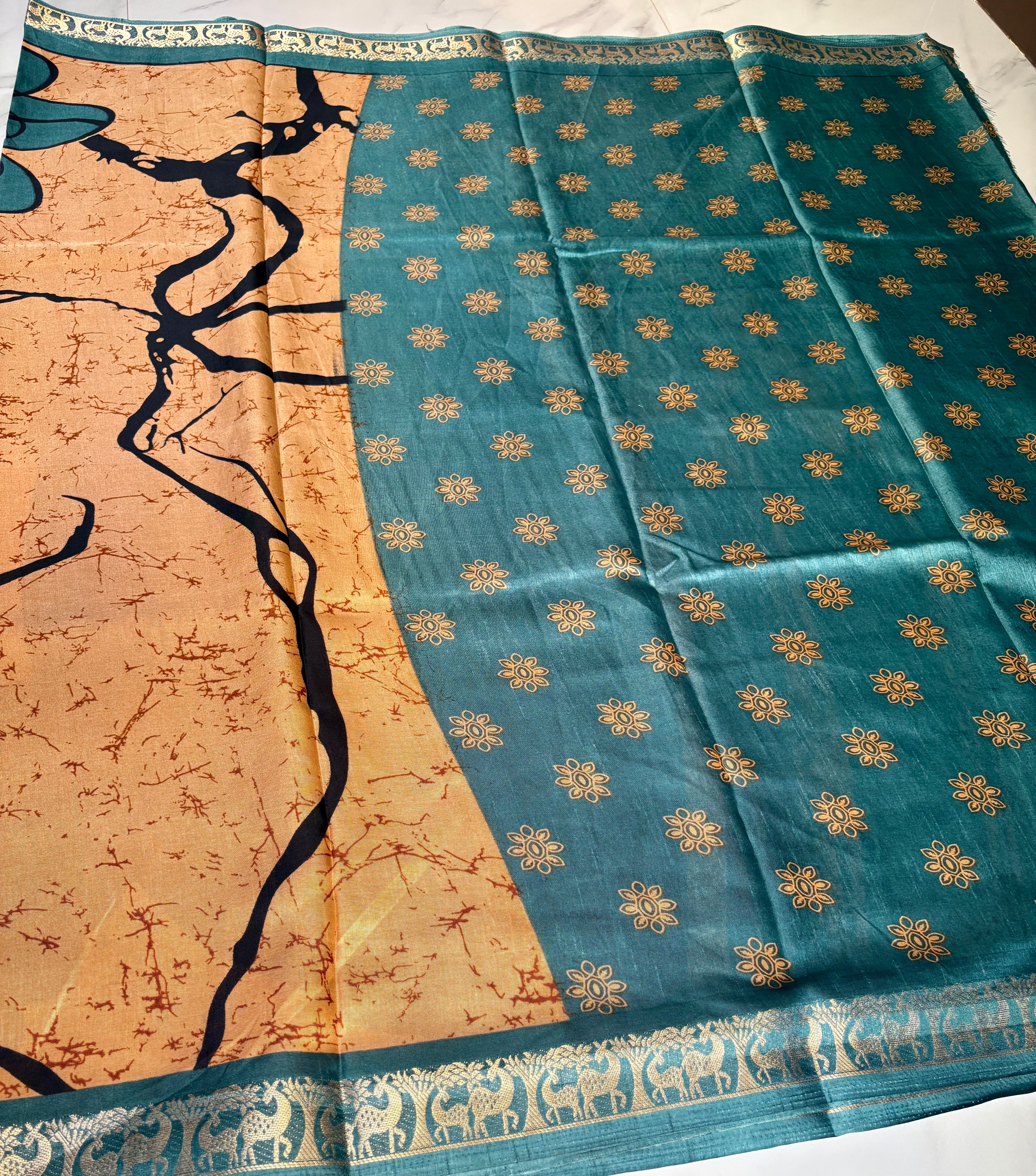 Elegant golden beige saree featuring a modern abstract print and a contrasting teal woven border with intricate traditional motifs - Satin Tissue Saree