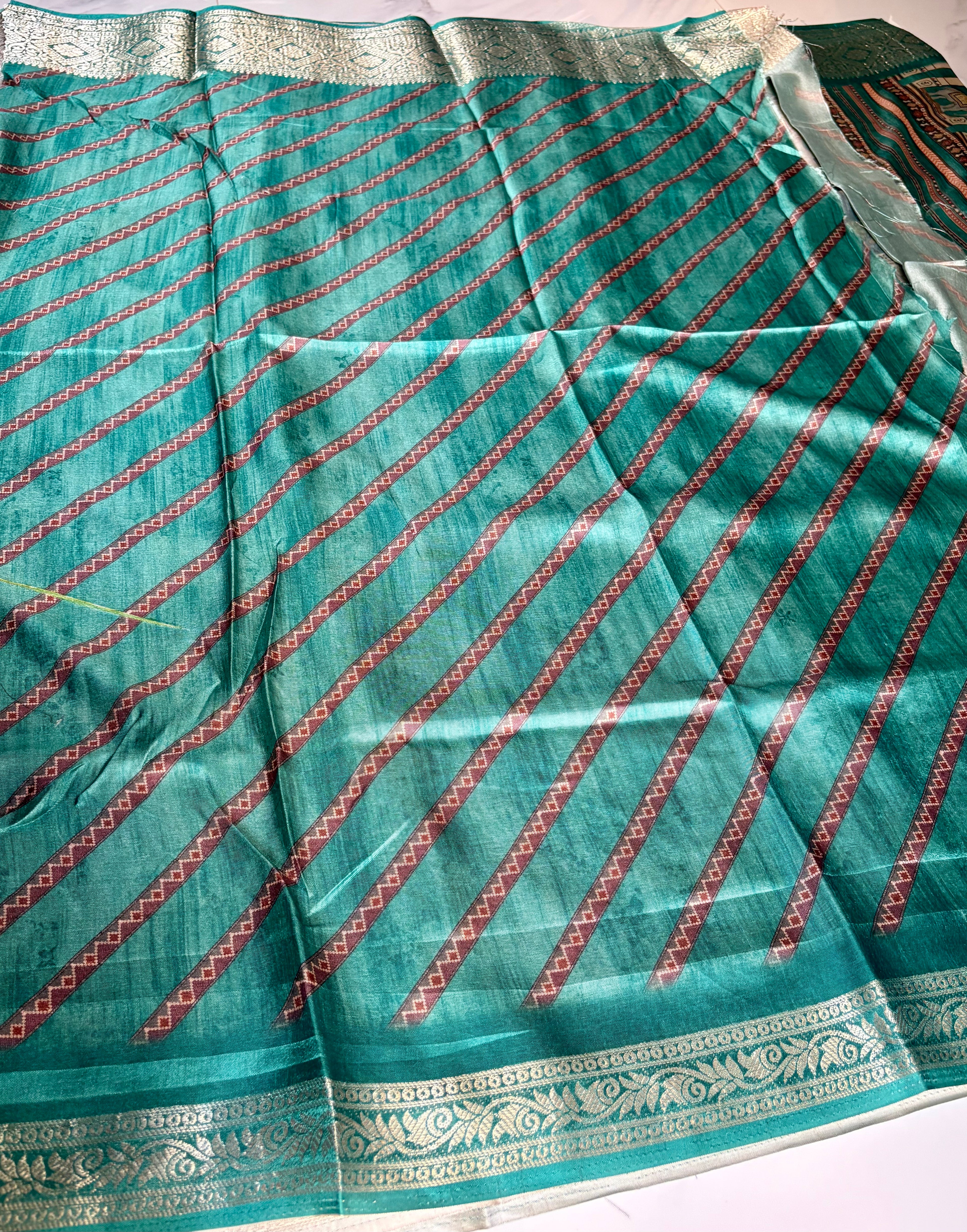 Elegant teal green printed saree featuring intricate heritage-inspired patchwork designs with rich woven zari border - Satin Tissue Saree