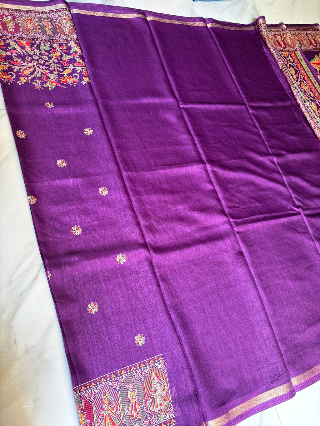 Elegant royal purple shade features delicate floral butta motifs across the body and subtle golden edging.