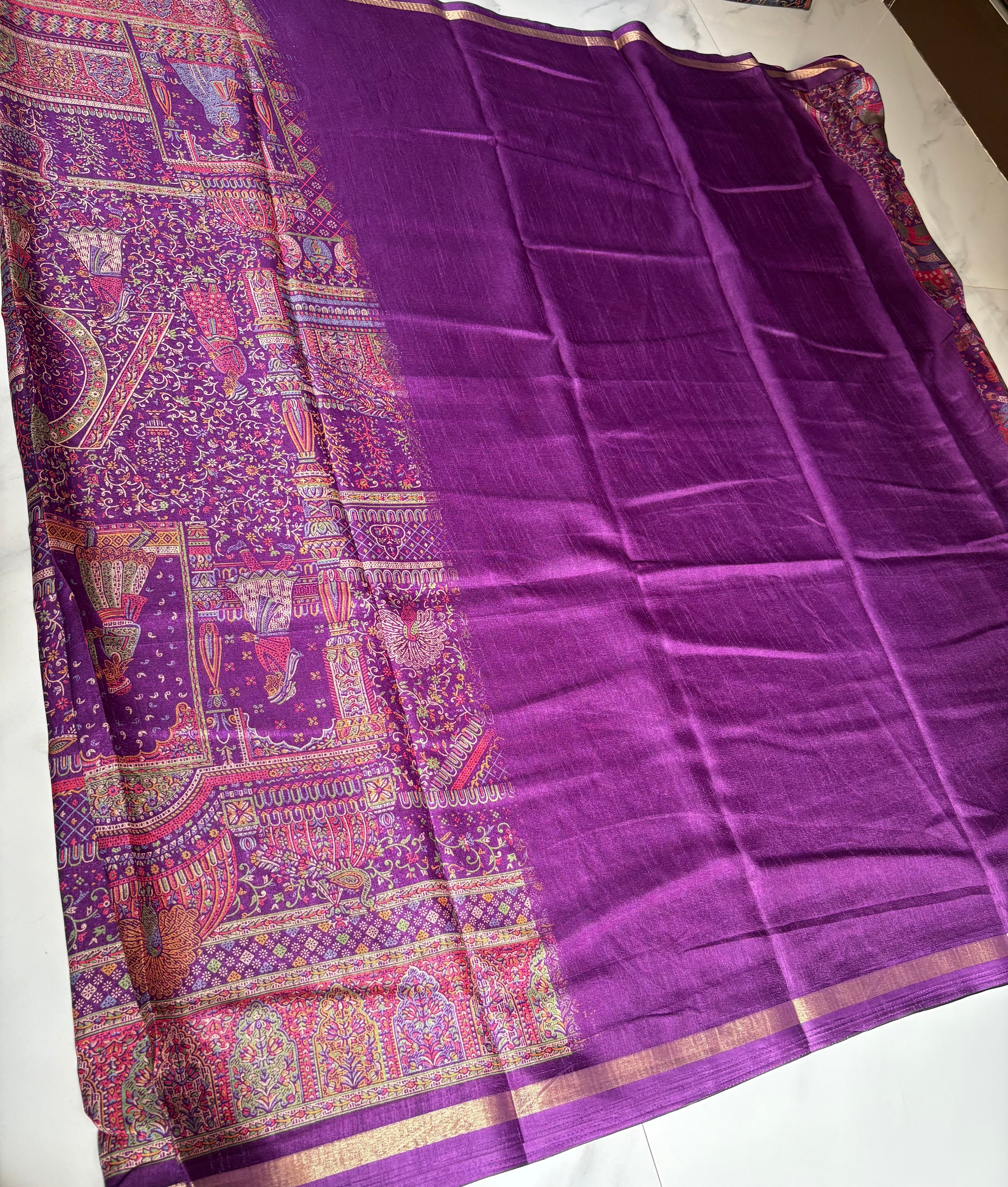 Elegant  royal purple saree, beautifully adorned with intricate multicolored traditional motifs  and subtle golden edging.