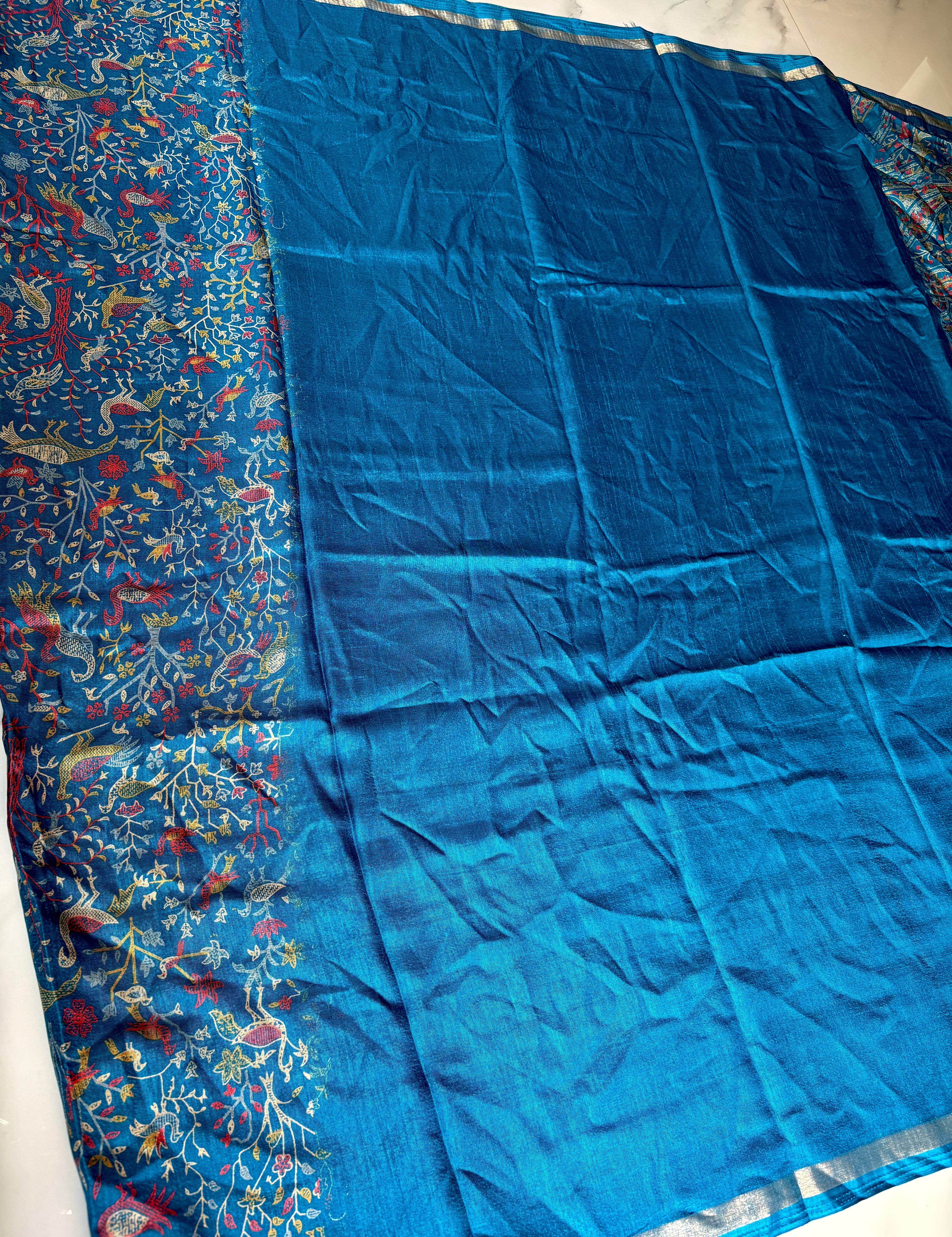 Elegant royal blue saree featuring an intricate all-over nature-inspired print and subtle Silver edging.